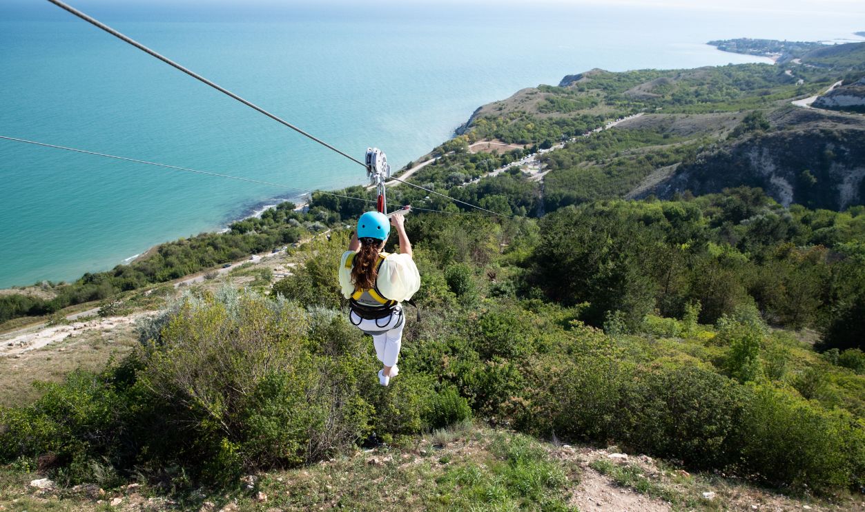 Experience the thrill of zip lining over a beautiful coastal landscape in Bulgaria