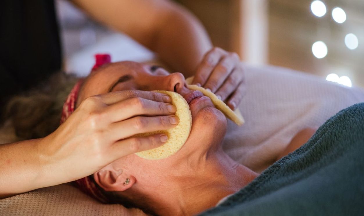 Woman receiving a rejuvenating spa facial massage indoors, promoting relaxation and tranquility