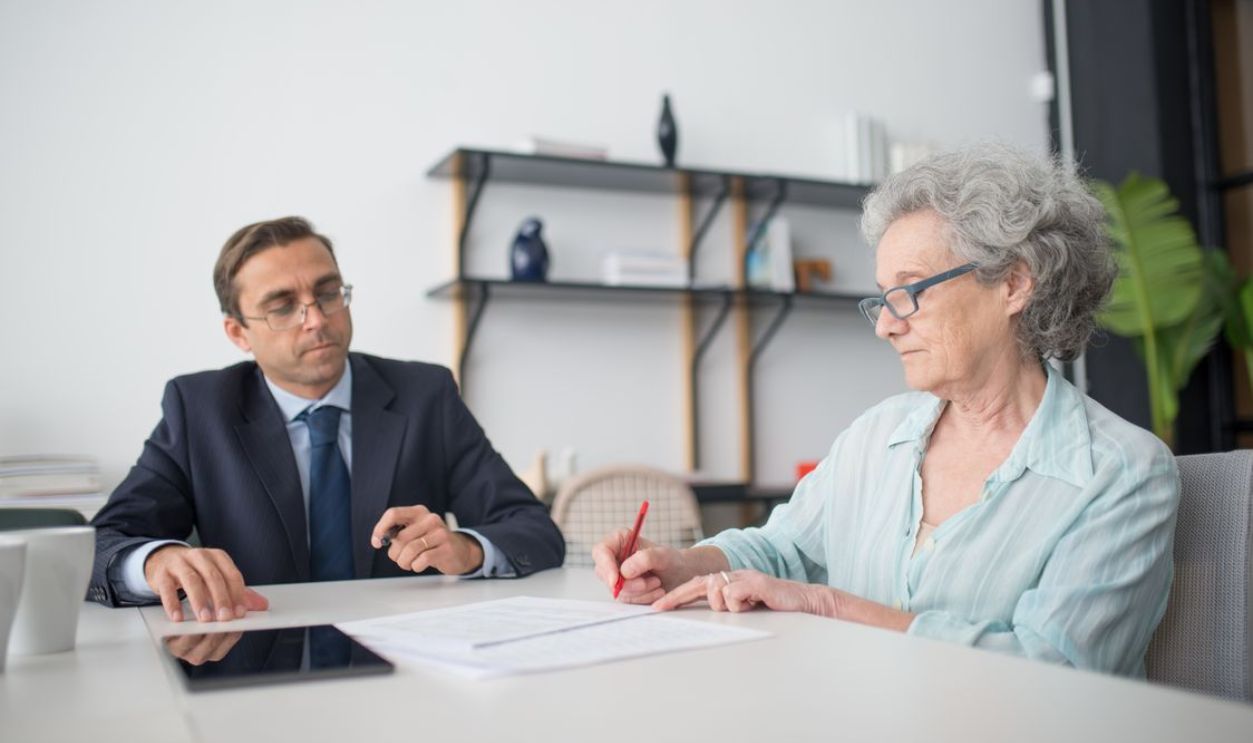 Old women signing a document