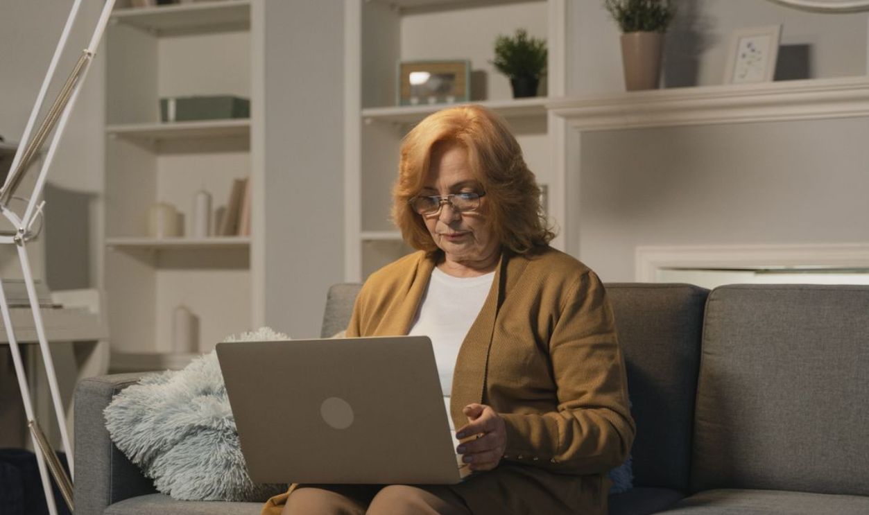 old women checking her laptop