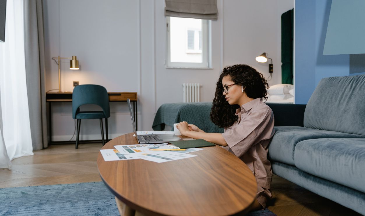 A woman working from home, focused on her laptop