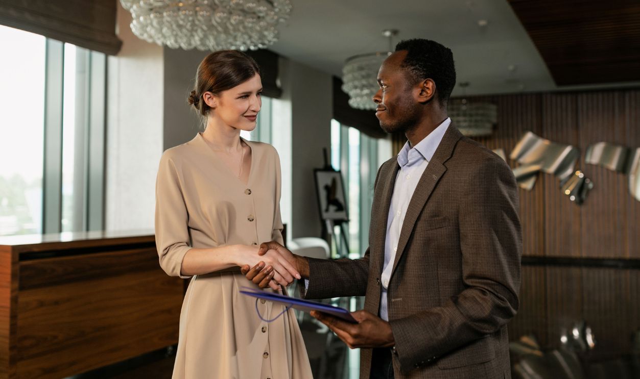 Professional handshake between colleagues in a modern office, symbolizing agreement
