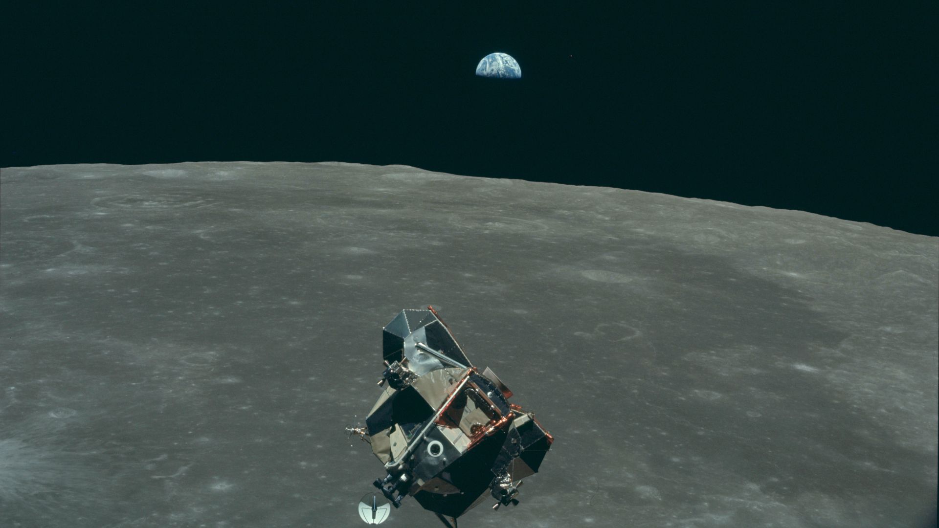 Earth, Moon and Lunar Module, in lunar orbit after return from the moon and before rendezvous with the  Apollo 11 Command/Service Module. Mars is visible as the red dot on the right-hand side of Earth. AS11-44-6643.