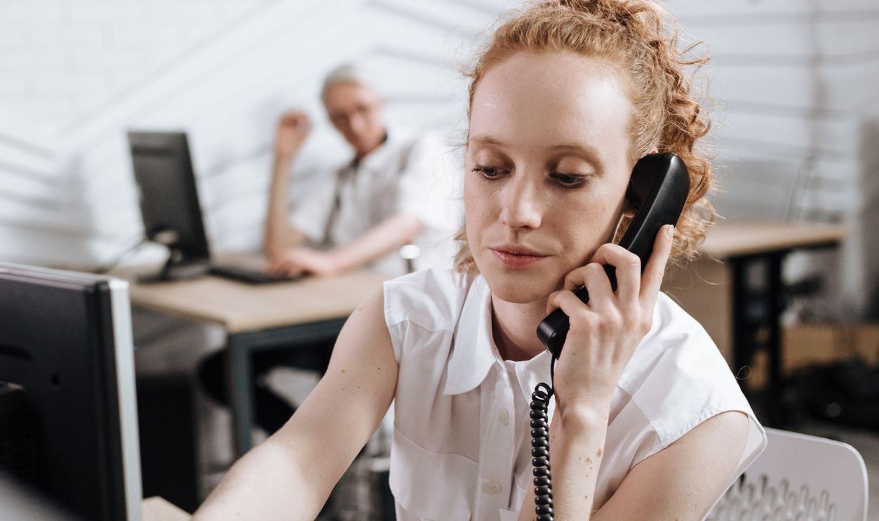 Focused businesswoman making phone call at her desk