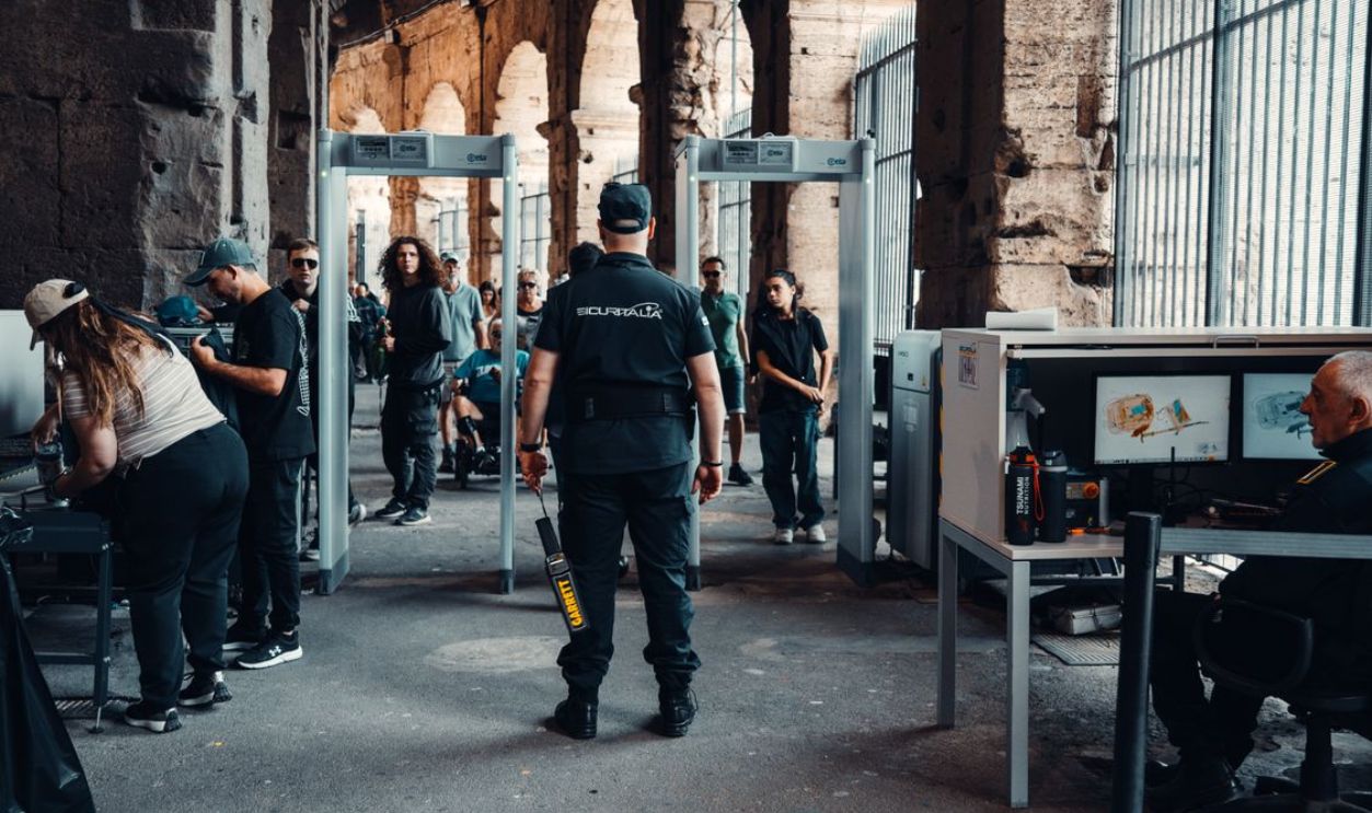 Security checkpoint with guards at a bustling historical site entrance.
