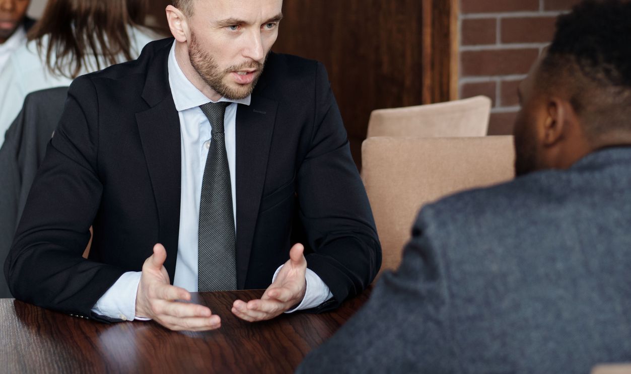 Professionals in suits having a focused business discussion in a stylish cafe