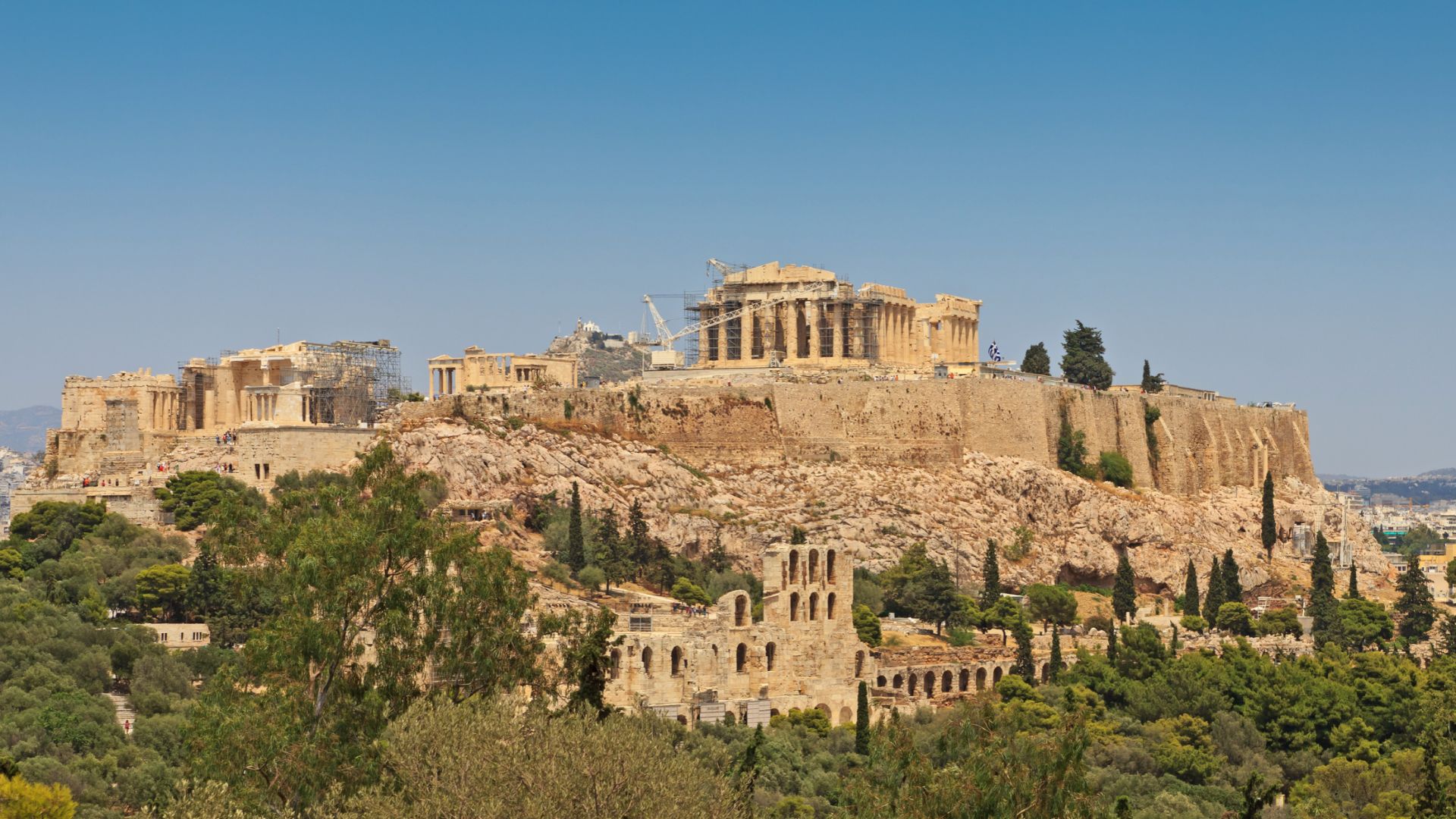 The Acropolis in Athens, located in the center of the city, with large monumental buildings at the top including the Parthenon