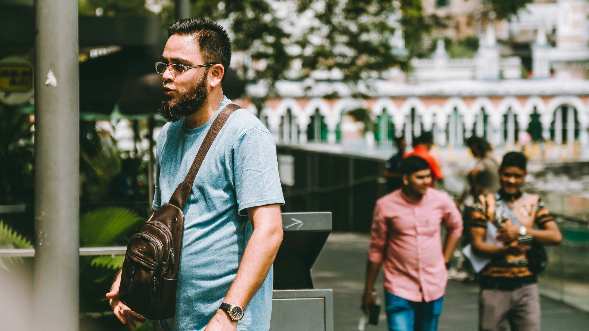 A man standing on a skateboard on a city street