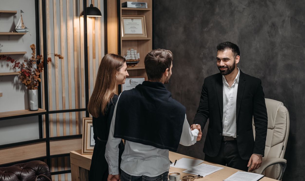 Professional business meeting in modern office setting with a handshake