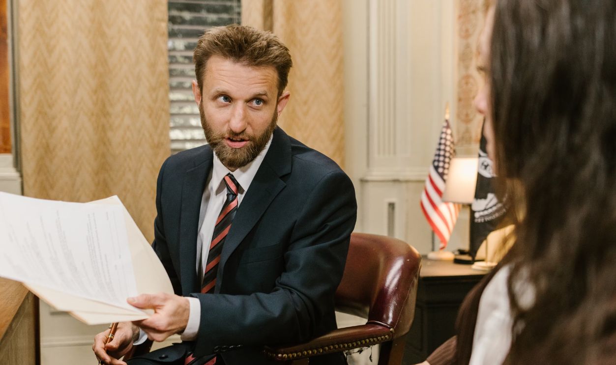 Professional discussion in an office setting with legal documents and business attire