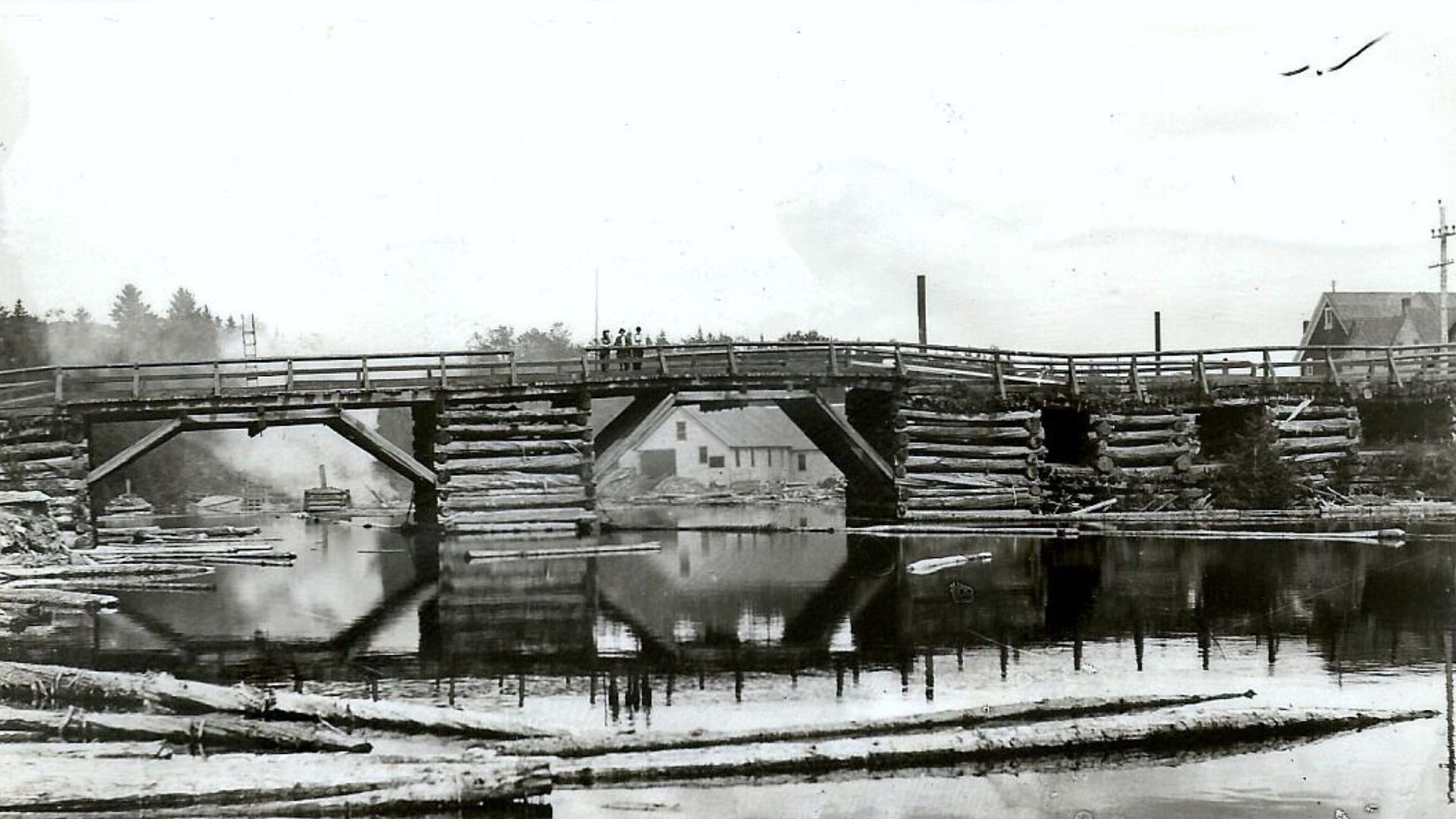 Bridge at Monticello, Maine on U.S. Route 1 over the North Branch of the Meduxnekeag River.  From a picture postcard circa 1907. The curved bridge was infamous for loss of lives from vehicle accidents, causing some to plunge into the Meduxnekeag River. Th