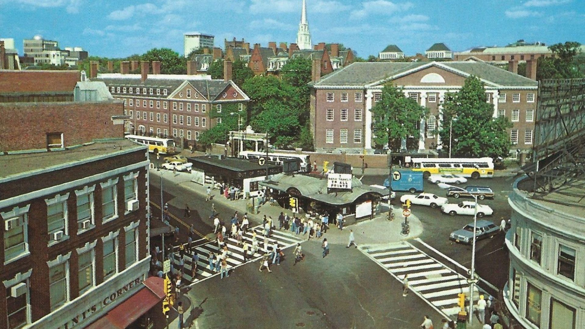 1970 postcard of Harvard Square, with the old subway kiosk and Out Of Town news at center