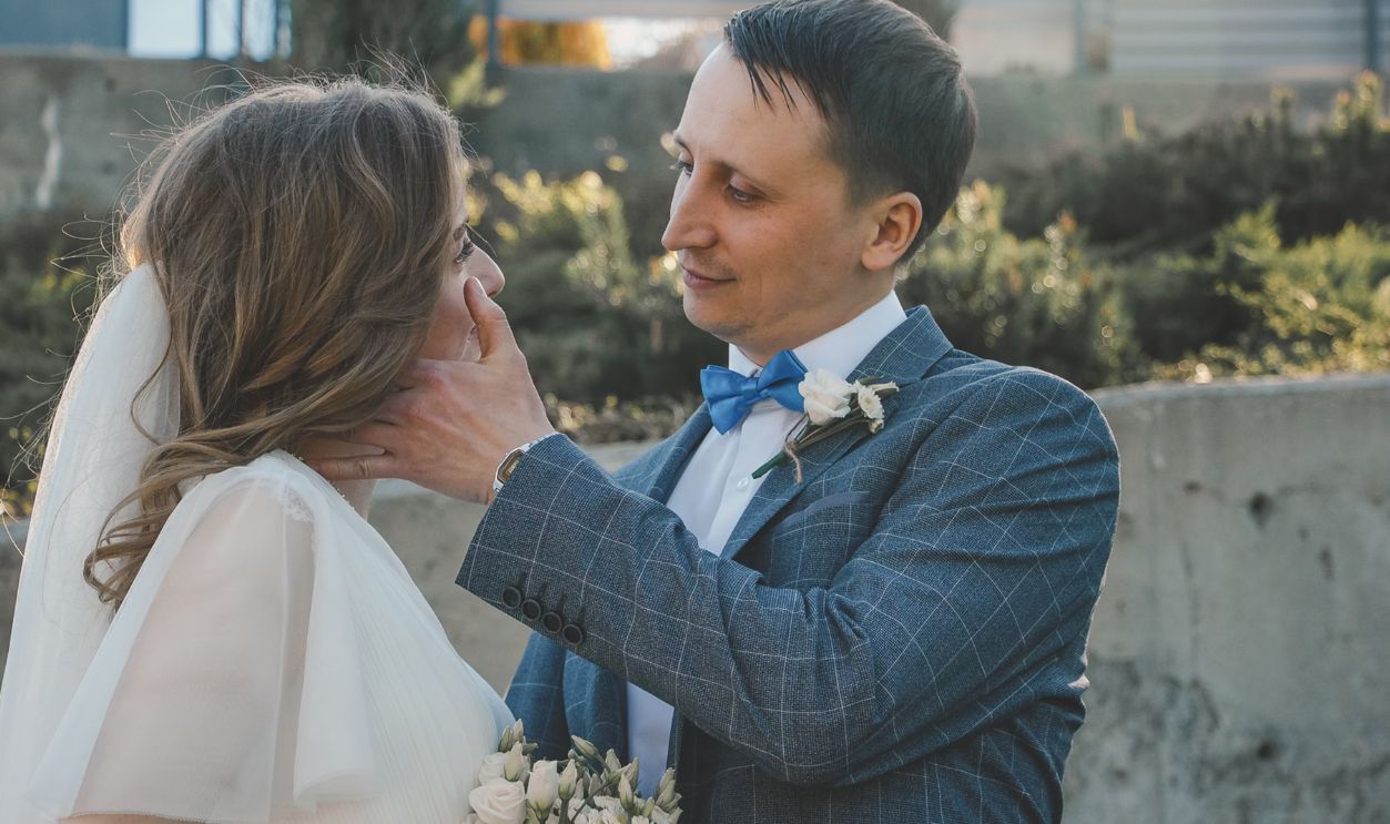 Newlywed couple sharing a tender moment outdoors, symbolizing love and commitment
