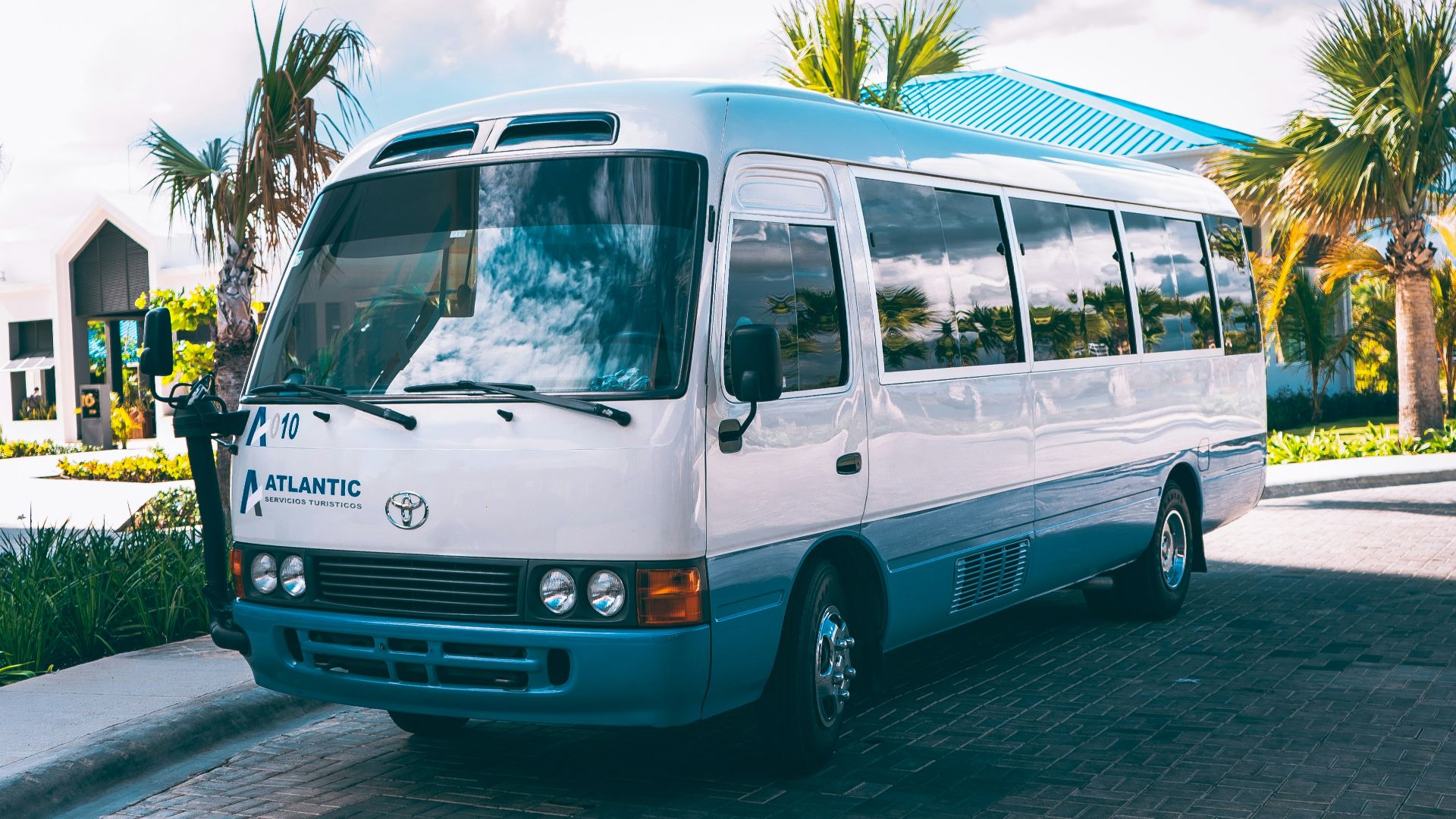 a white bus parked on the side of the road