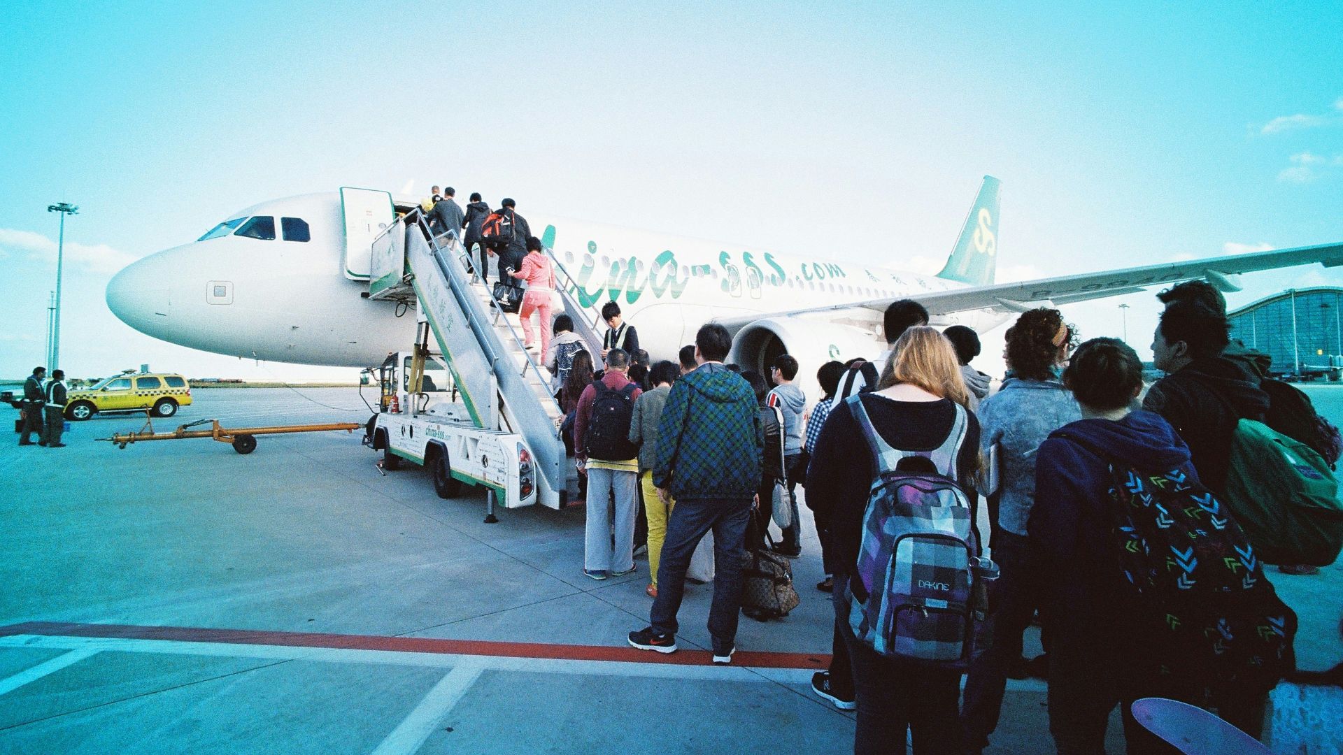people about to enter plane during daytime