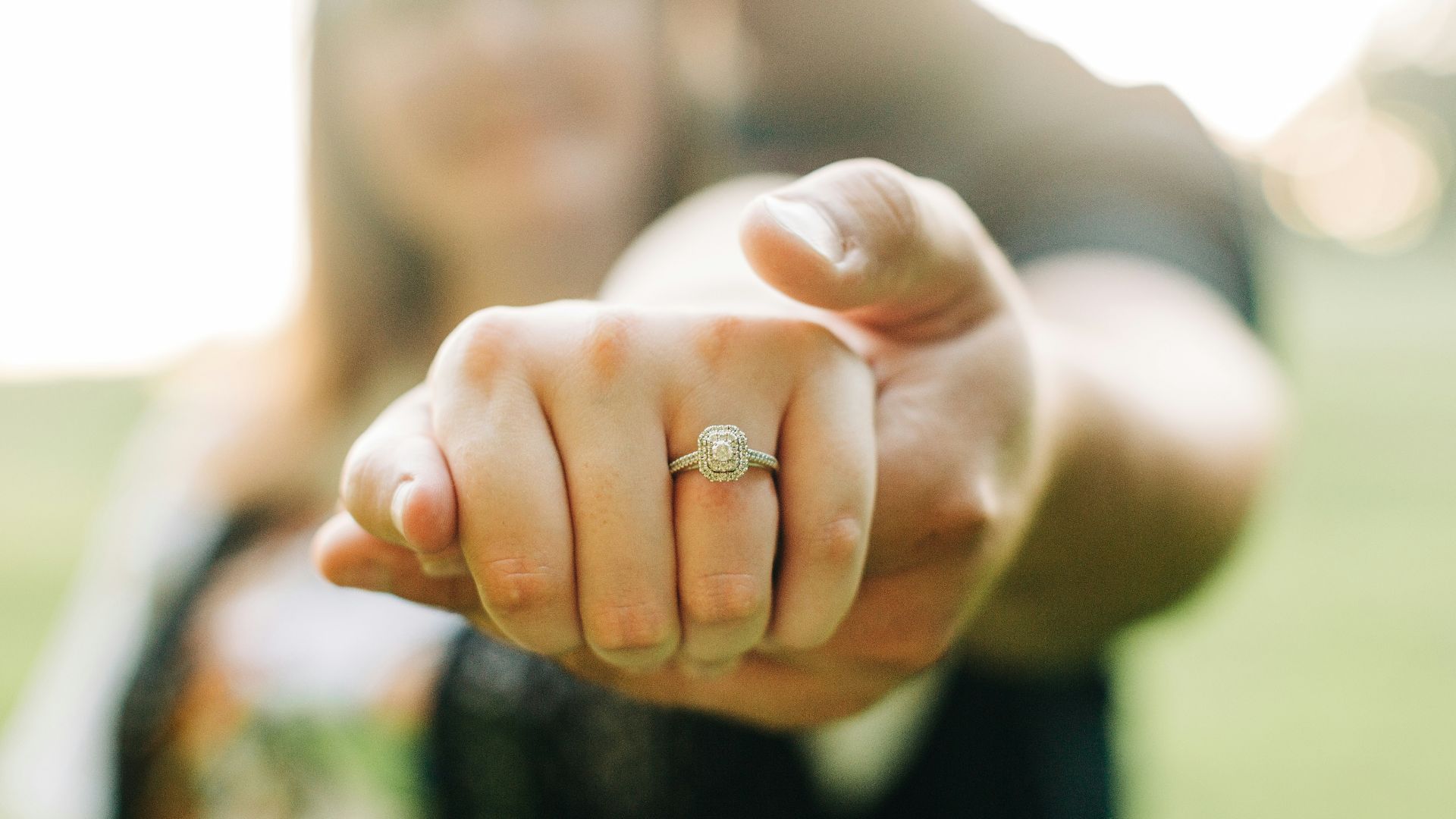 person wearing gold wedding band