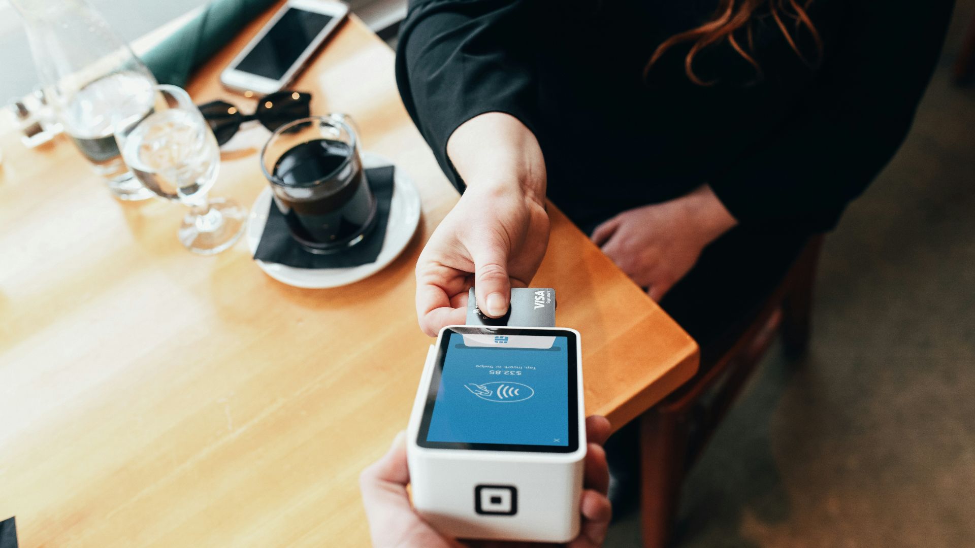person holding credit card swipe machine