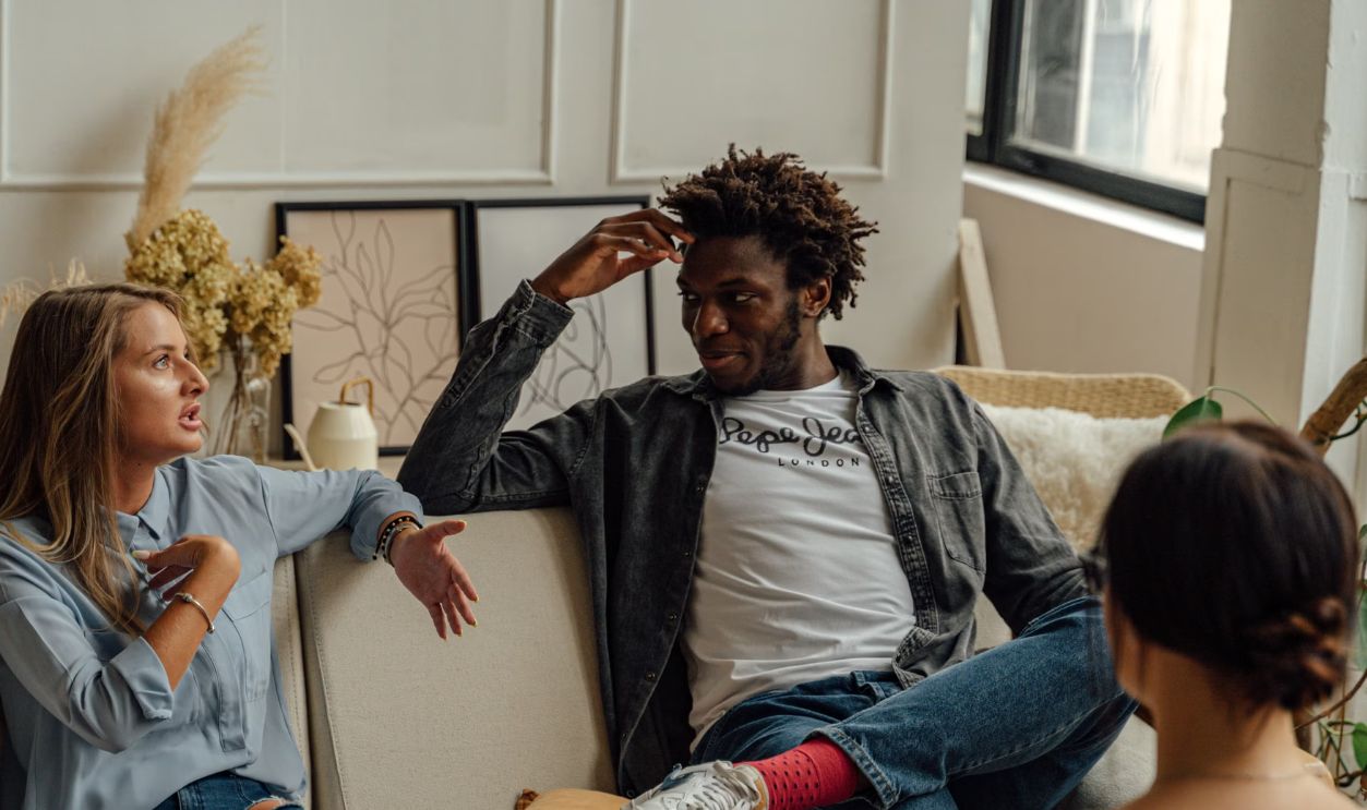 A couple is engaged in a lively conversation during a therapy session with a counselor
