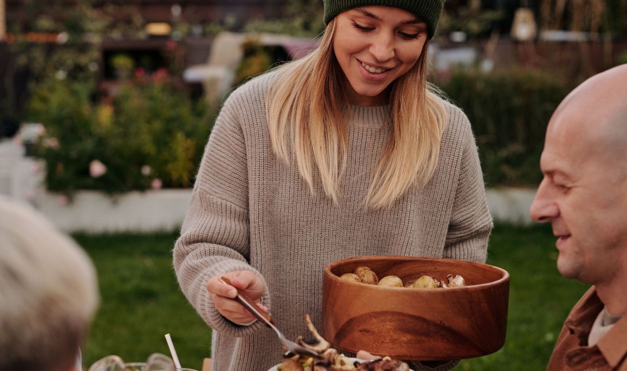 Joyful evening among friends sharing a meal outdoors with fresh food and laughter