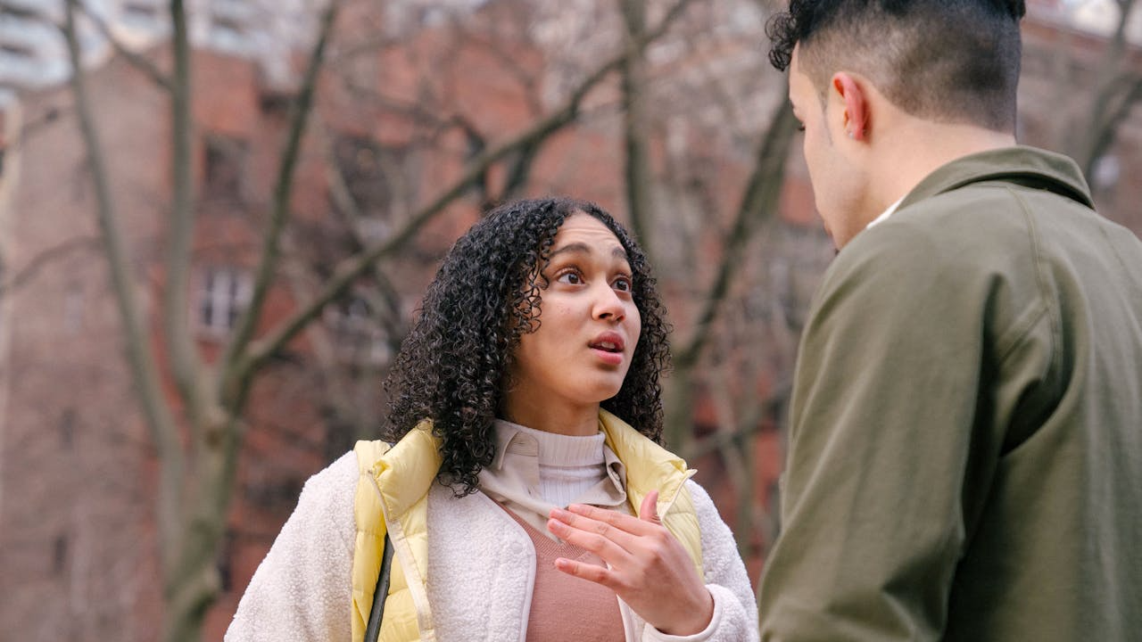 Ethnic couple arguing on street in daytime