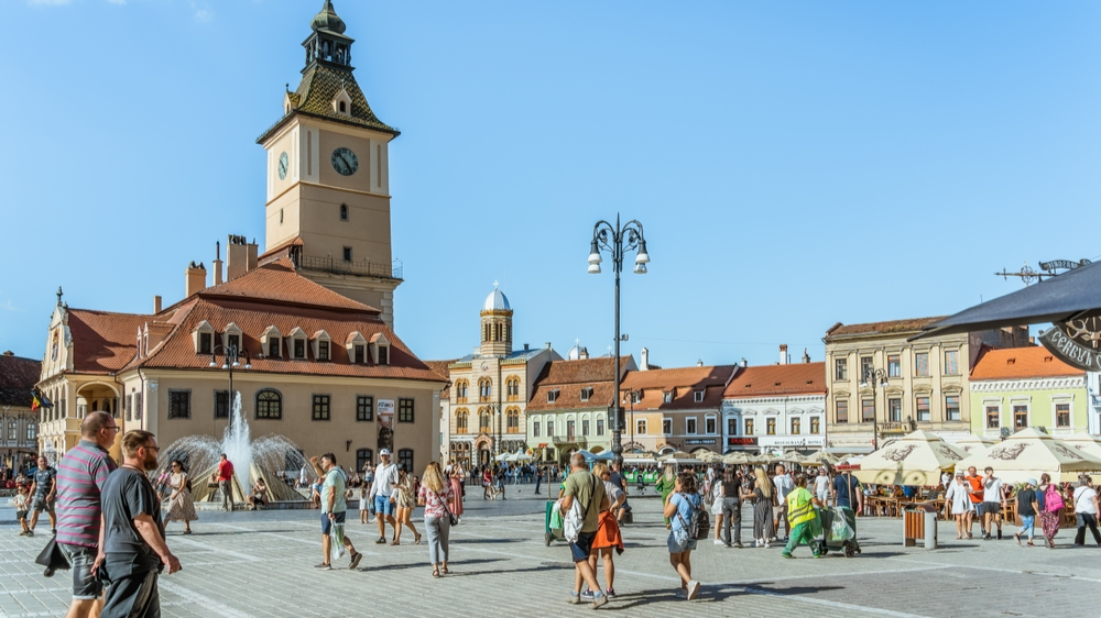 Tourists and locals strolling on the pedestrian area in the old town center of Brasov.Romania 2023