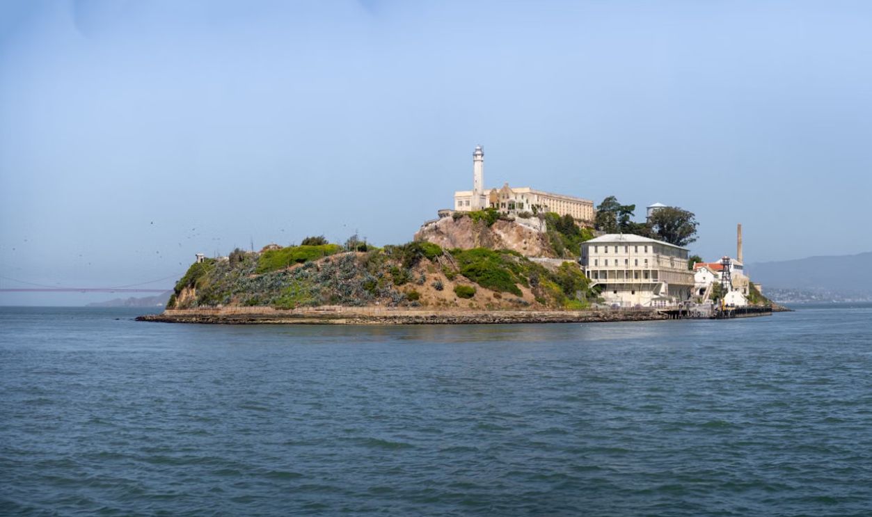 A scenic view of Alcatraz Island and its historic buildings in San Francisco Bay