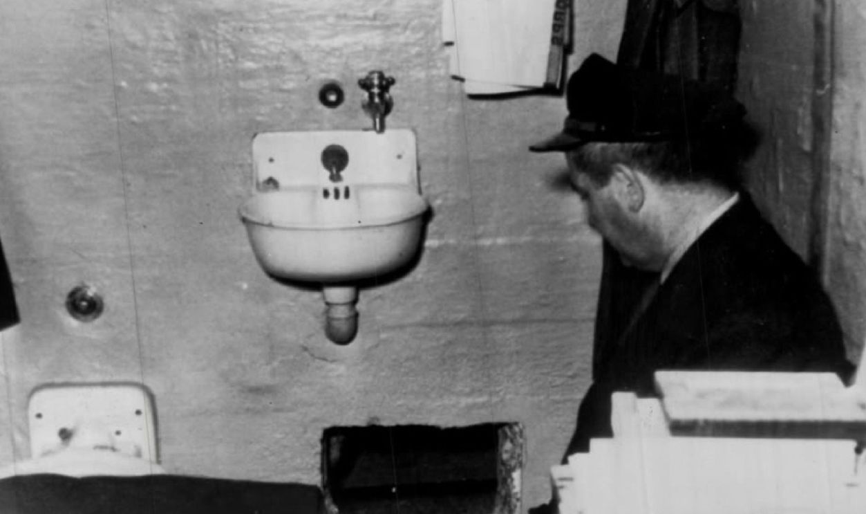 Denver Post Archives JUN 14 1962, DEC 5 1993 Where Alcatraz Prison Break Started A prison guard kneels by hole in Frank Morris' cell through which he and John and Clarence Anglin escaped. Prison officials report hole was dug with broken spoons. Credit: Denver Post Rush Art