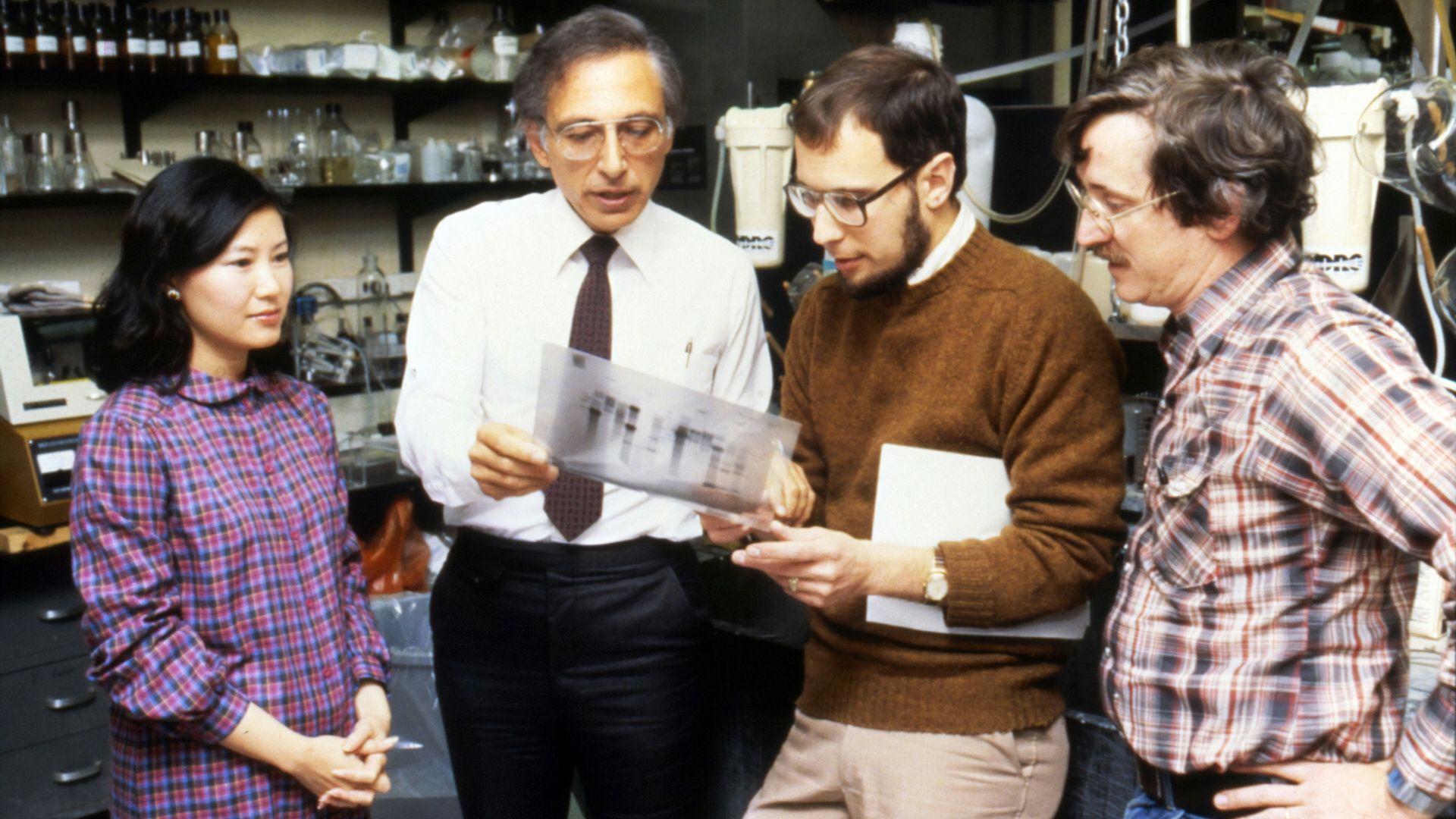 three men standing beside woman