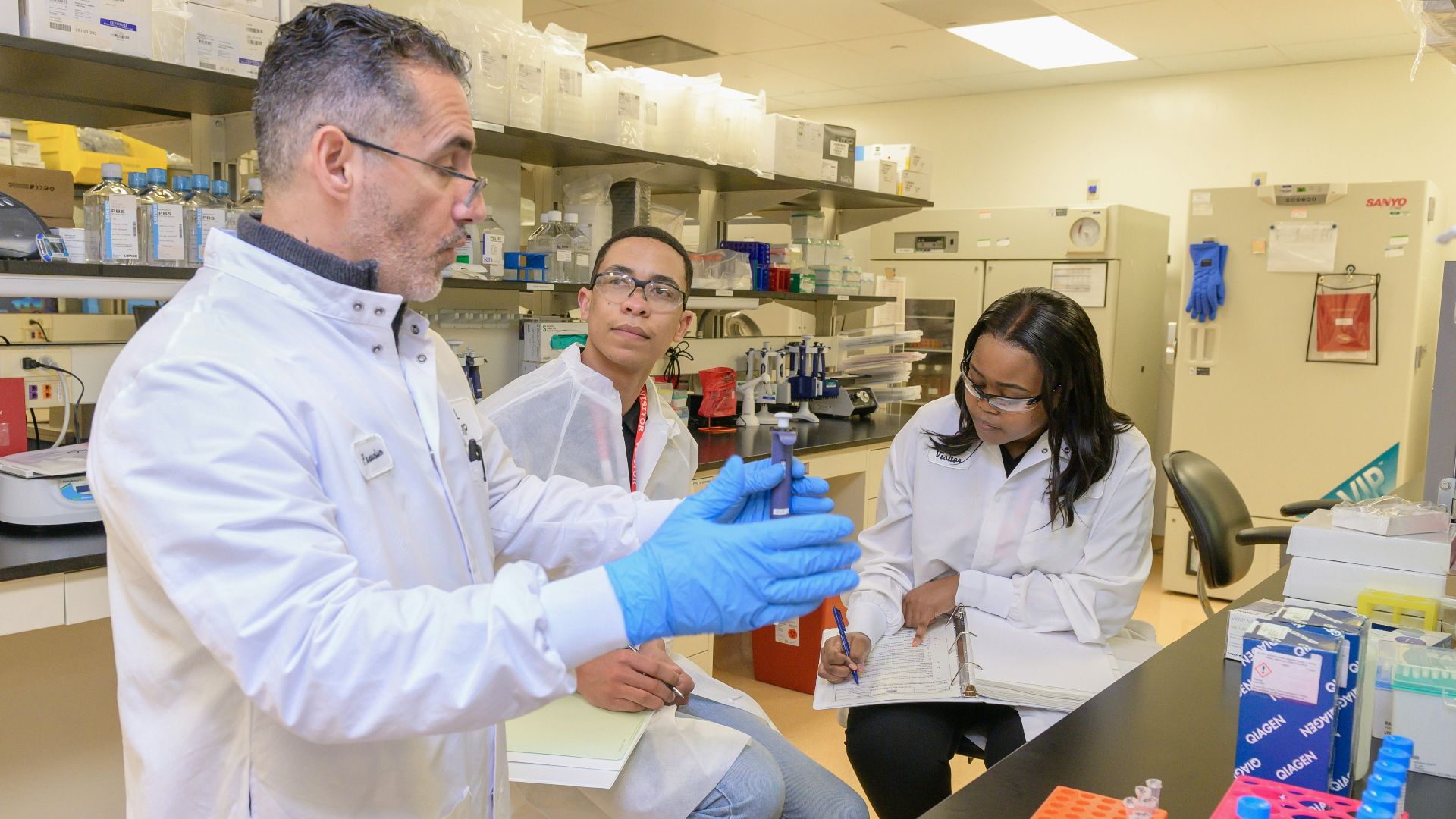 a group of people in a lab looking at something
