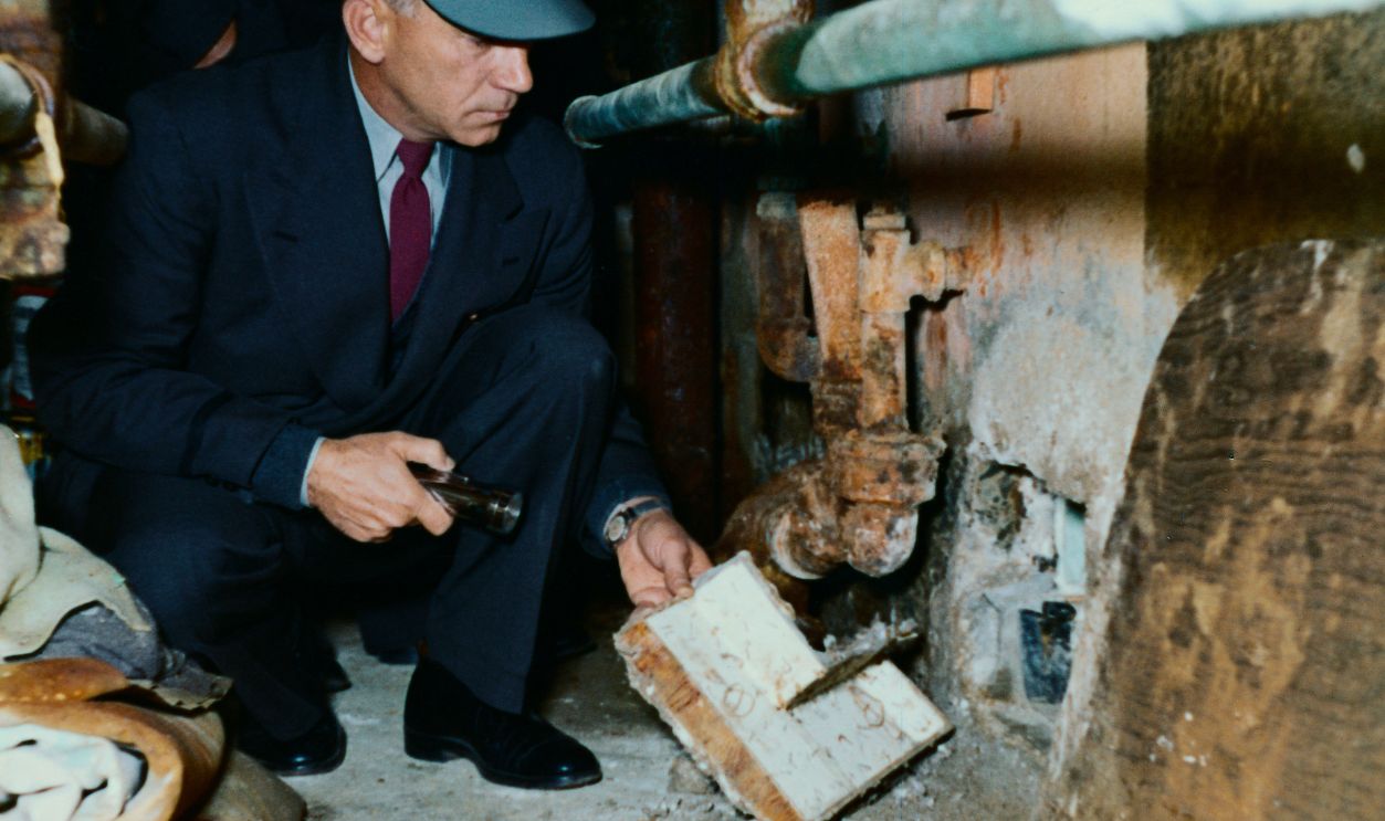 Officer Displaying Exit Used in Alcatraz Breakout Here is one of the cells in Cell Block B in Alcatraz Prison in San Francisco Bay from which three prisoners escaped 6/12. Here is an officer showing the inside of removable section of exit cover.