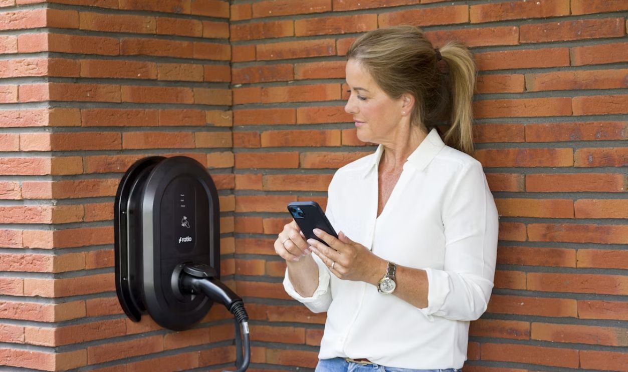 EV driver checking reviews charging station phone