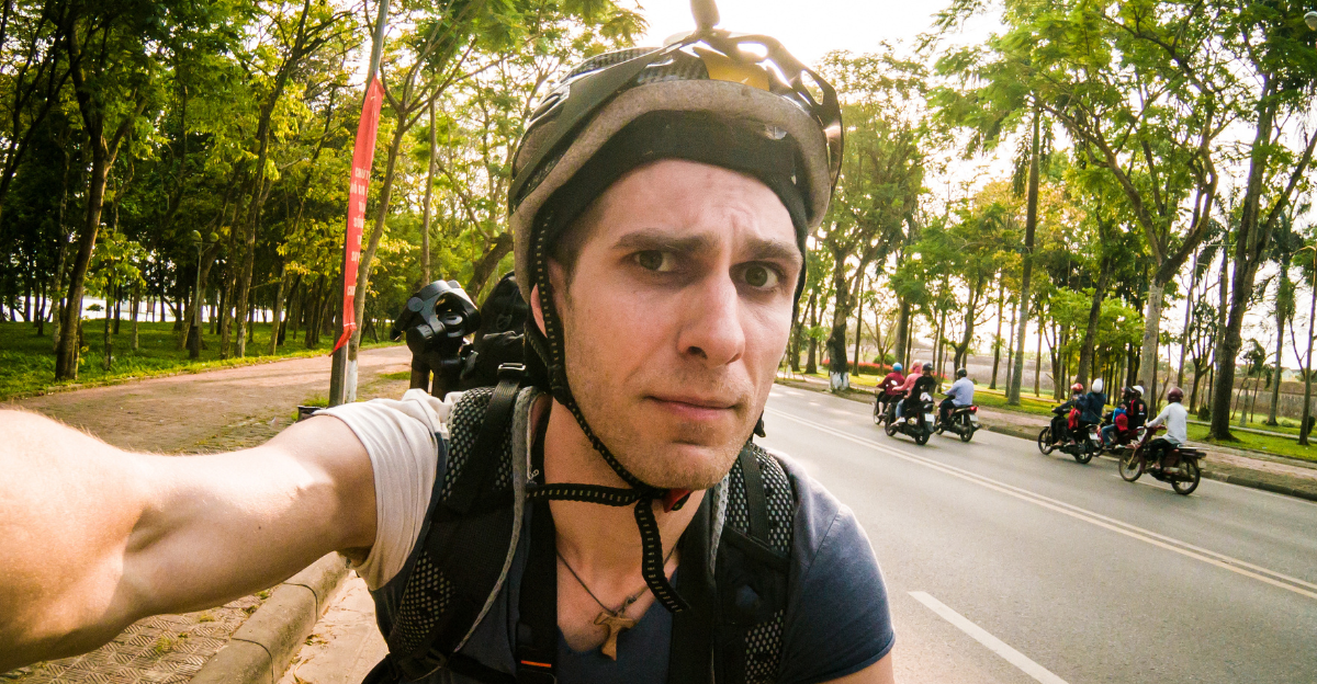 Guy cycling on a bike with concerned face