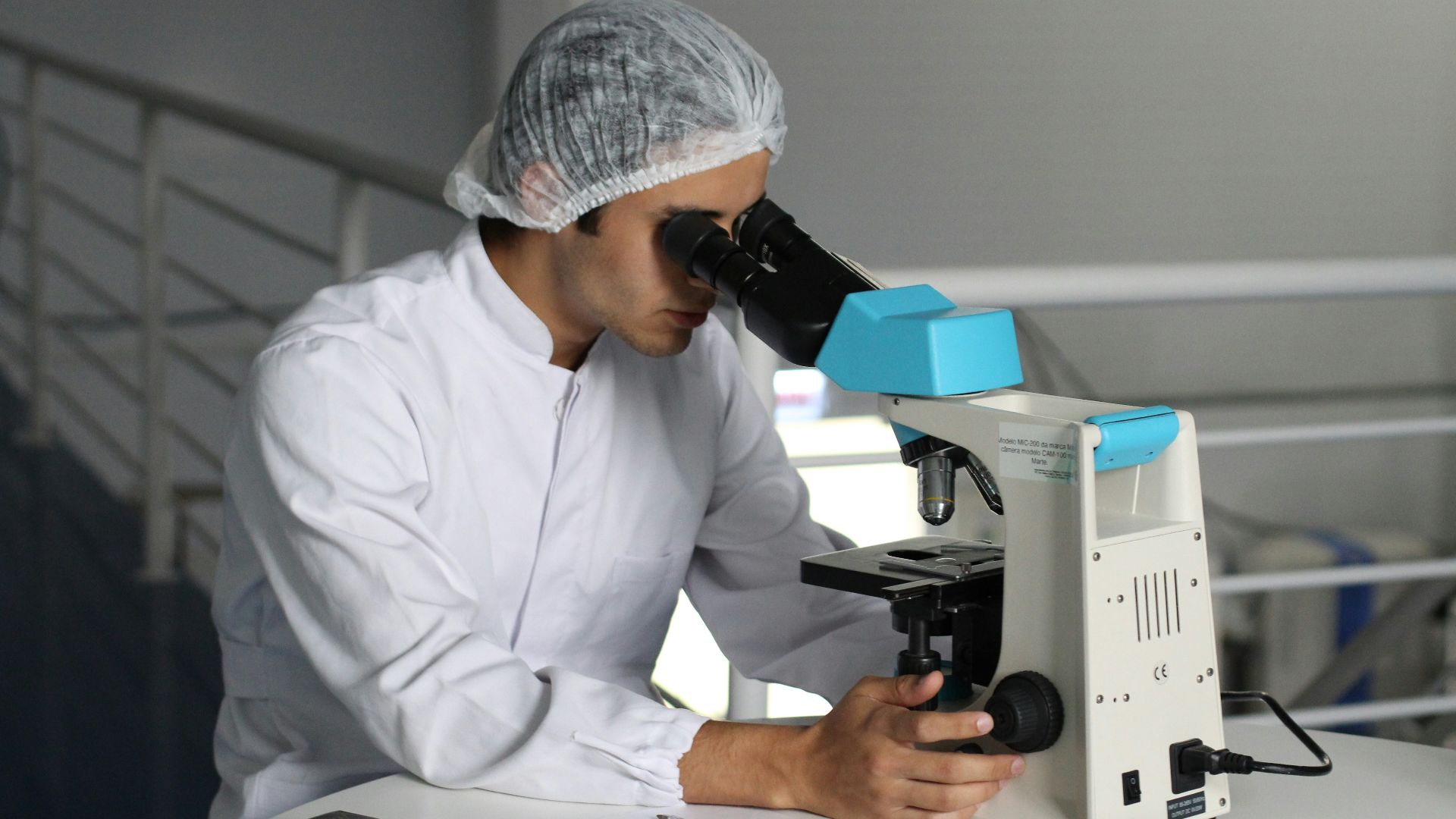 man sight on white microscope
