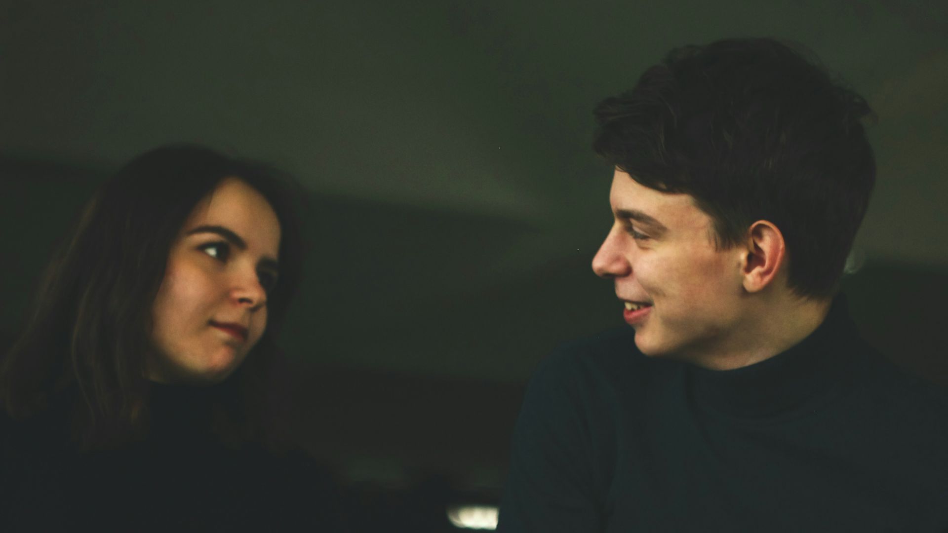 man wearing black shirt smiling at woman