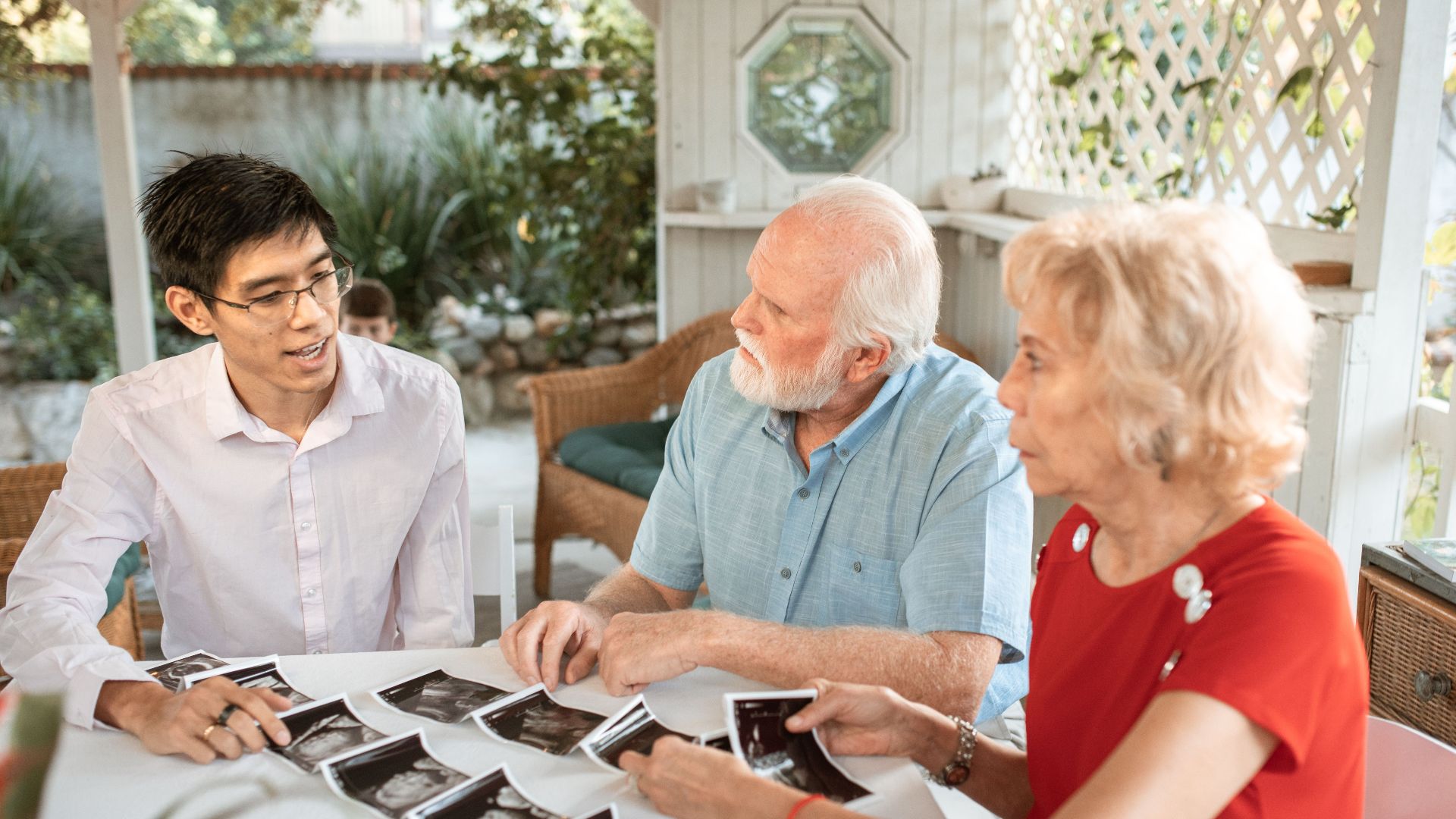 Family sits together discussing ultrasound images, celebrating new life.