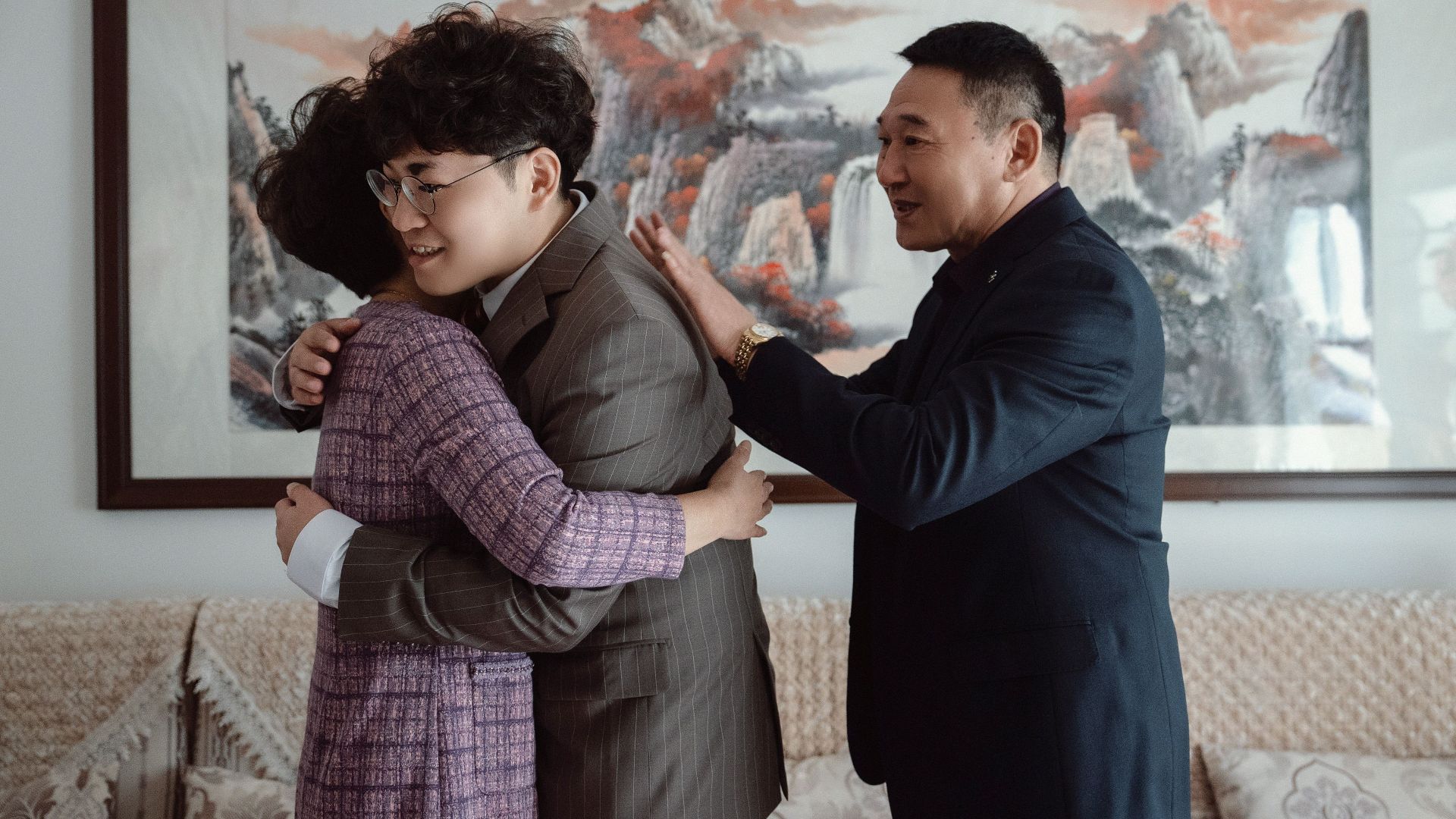 A touching family reunion with warm hugs and smiles indoors, celebrating togetherness.