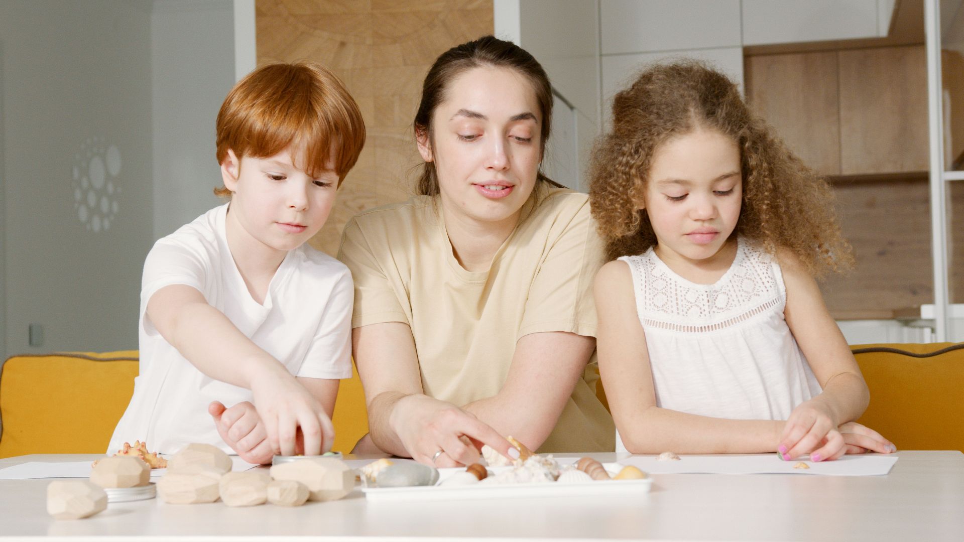Mother and children engaged in a creative activity at home, fostering bonding and togetherness.