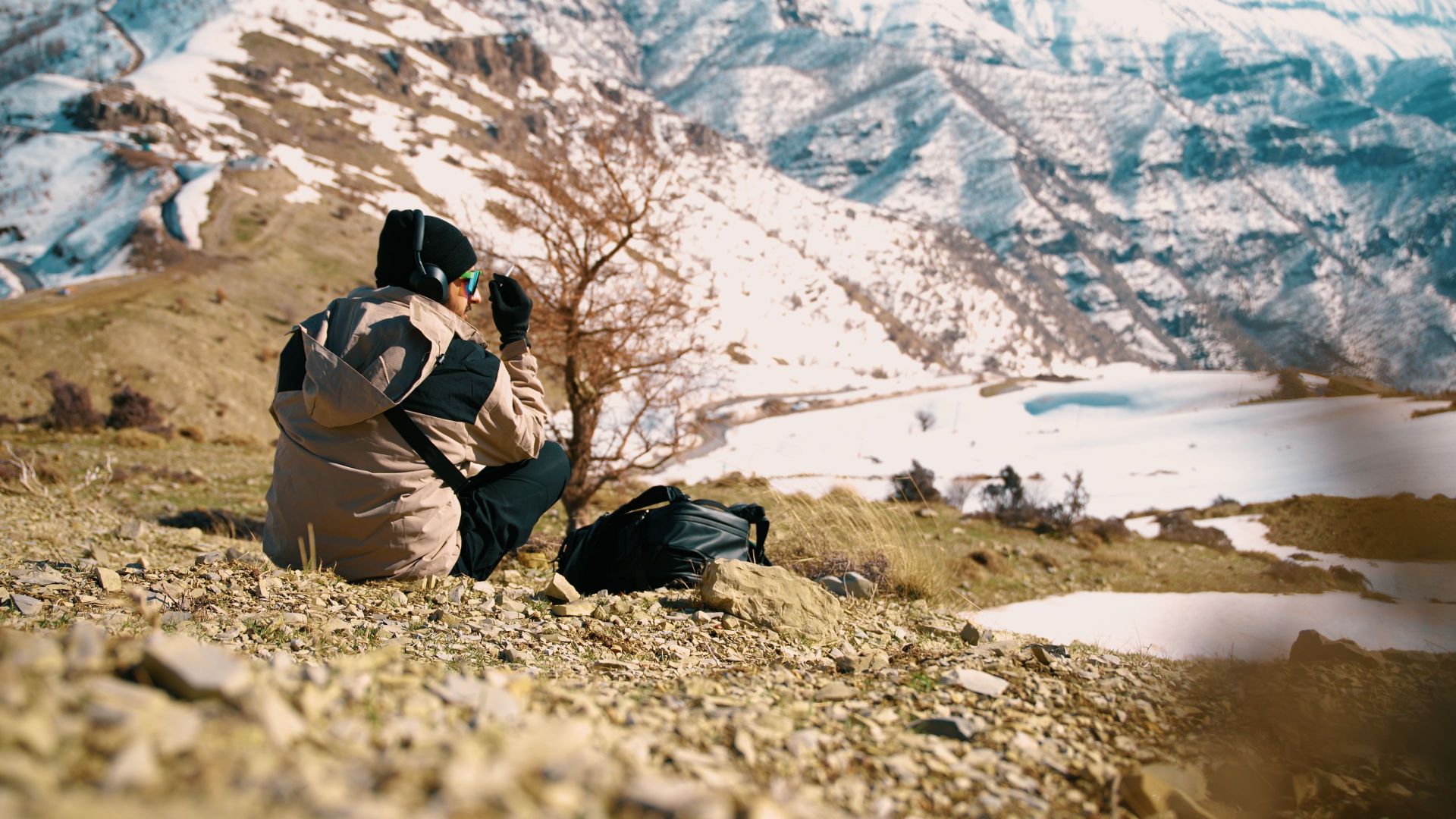 Person capturing the scenic snowy mountains. Winter adventure exploration.