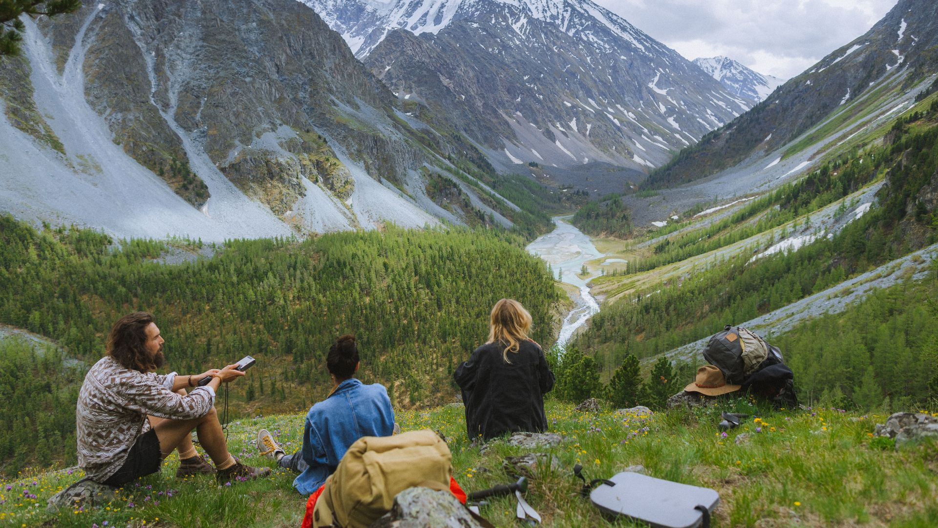 Explore stunning views of the Altai Mountains with hikers enjoying the serene landscape.