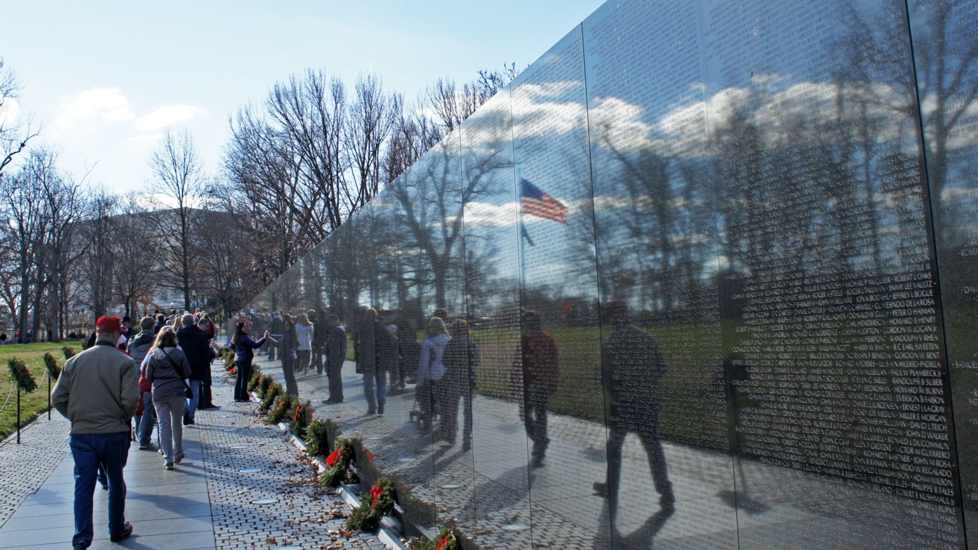 US flag reflexion on the Vietnam Veterans Memorial Wall, National Mall, Washington, D.C.