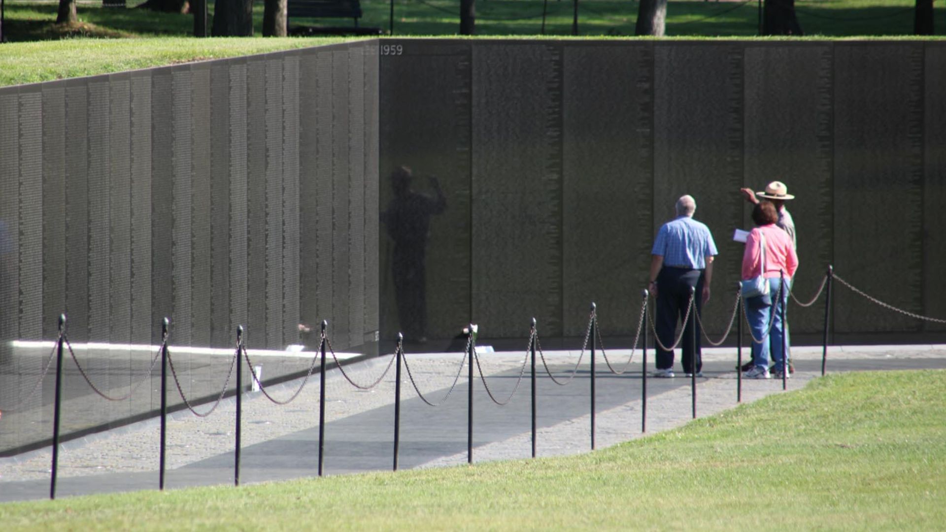 A National Park Service ranger discusses the Vietnam Veterans Memorial with tourists.

It is very rare to not see the memorial thronged with people.