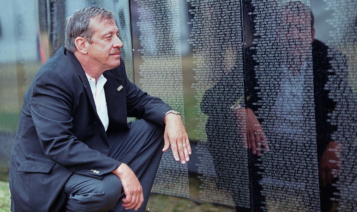 Jan Scruggs, founder and president of the Vietnam Veterans Memorial Fund, looks at the traveling Vietnam Memorial wall in the Boston Common. 