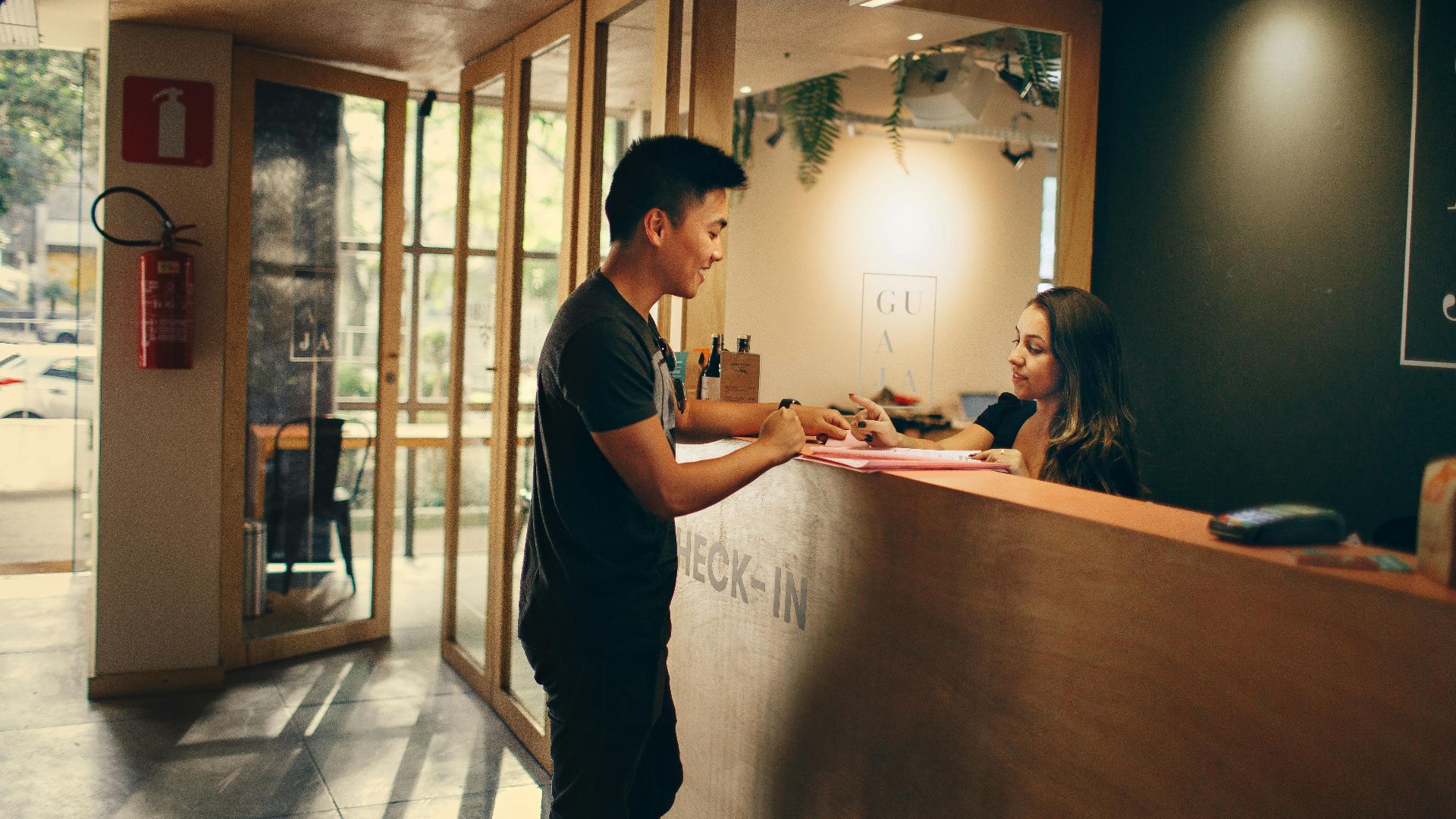 A customer checks in at a hotel reception desk in Belo Horizonte, Brazil.