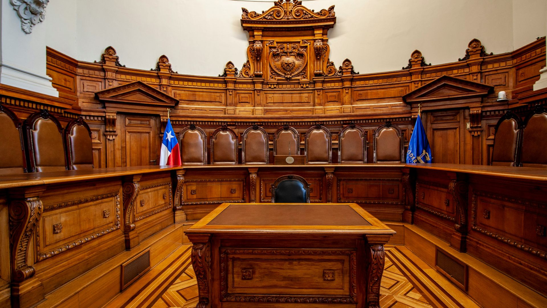 a courtroom with a large wooden bench