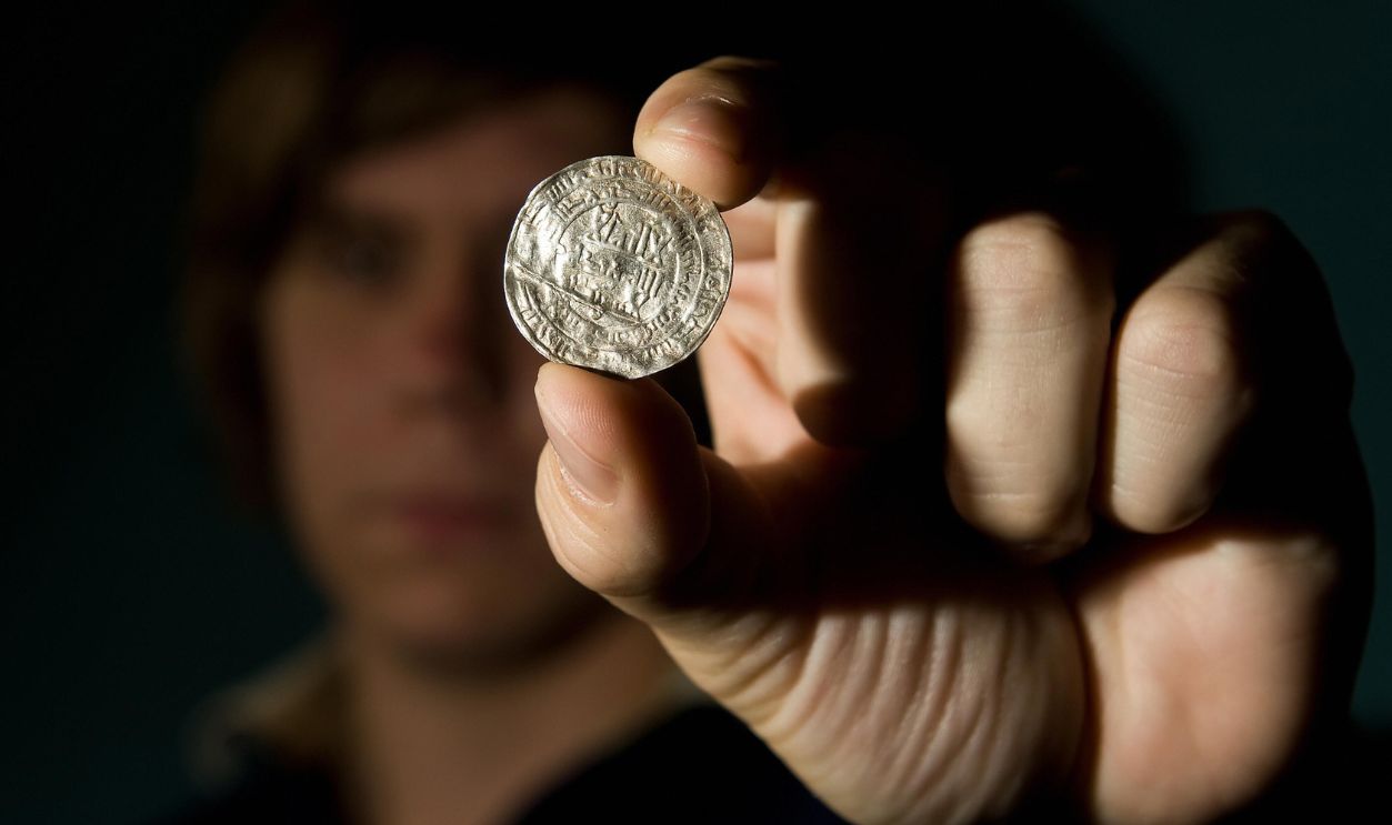 Getty Images - 90108652 - A siilver coin from the Vale of York viking hoard is displayed at a press conference to unveil the newly conserved hoard at the British Museum in central London, on August 27, 2009. Worth GBP 1.1m (dollars 1.8m or euro 1.3m) the items will be displayed equally between joint-owners York Museums Trust (York) and the British Museum.