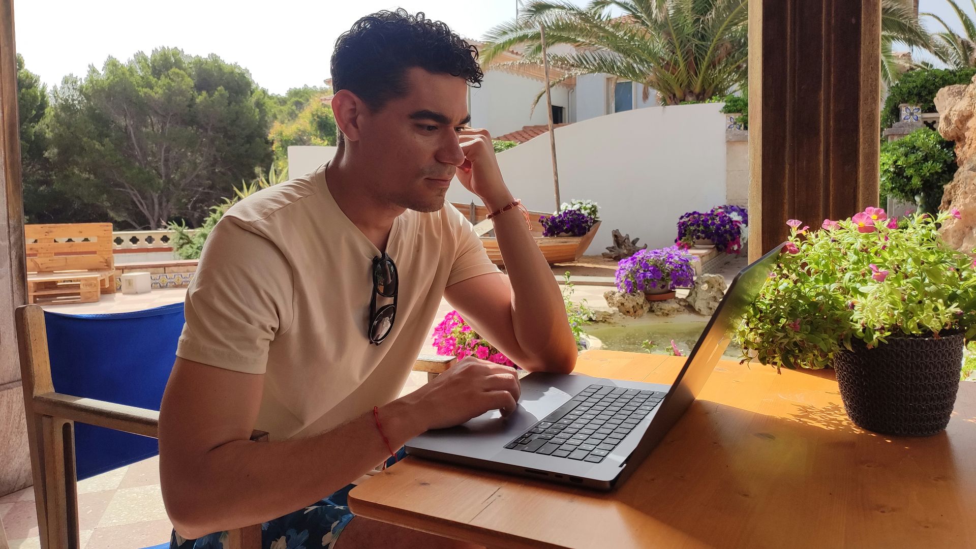 a person sitting at a table with a laptop
