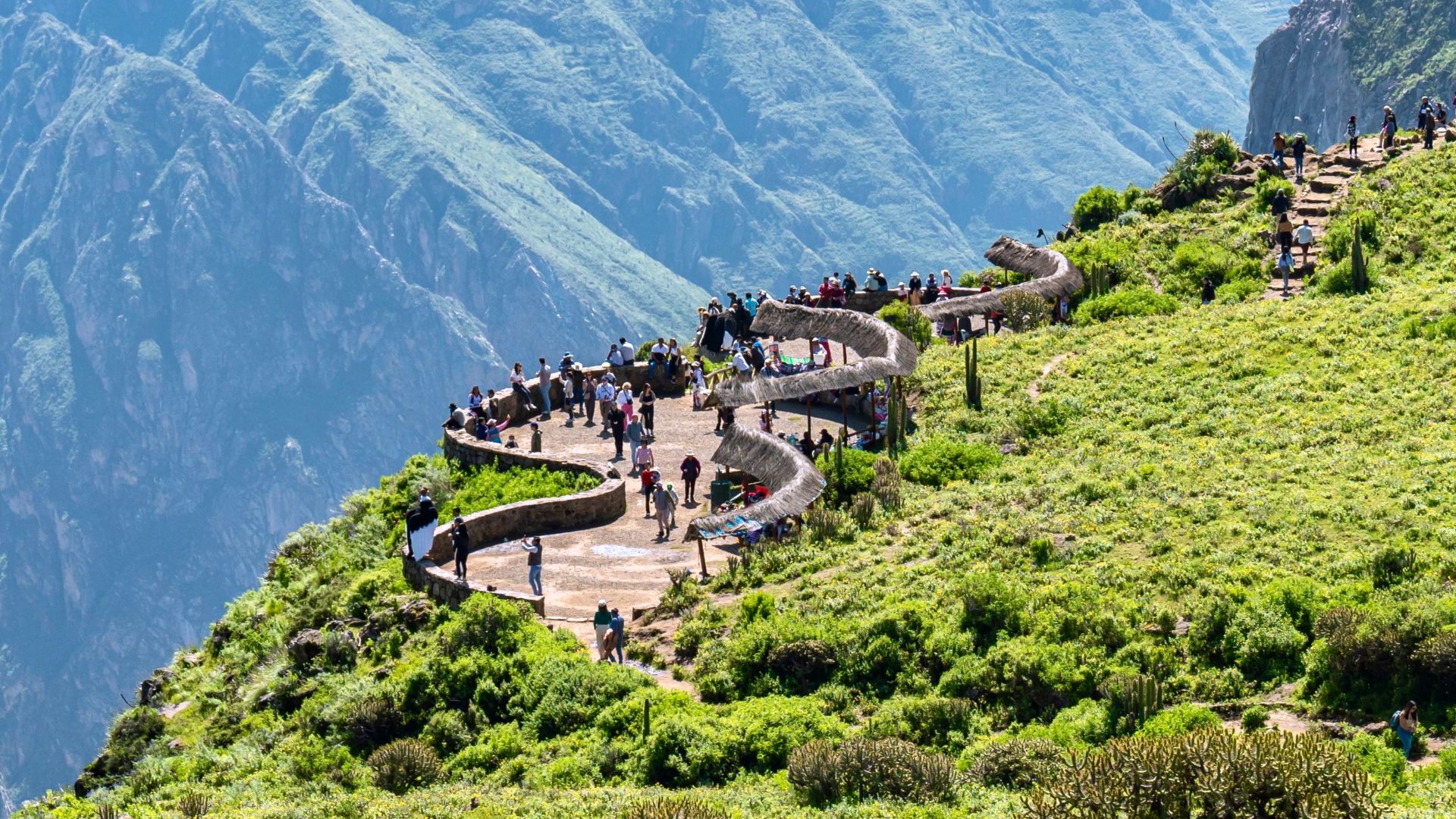 Tourists enjoy a breathtaking view from a scenic overlook at Colca Canyon in Arequipa, Peru.