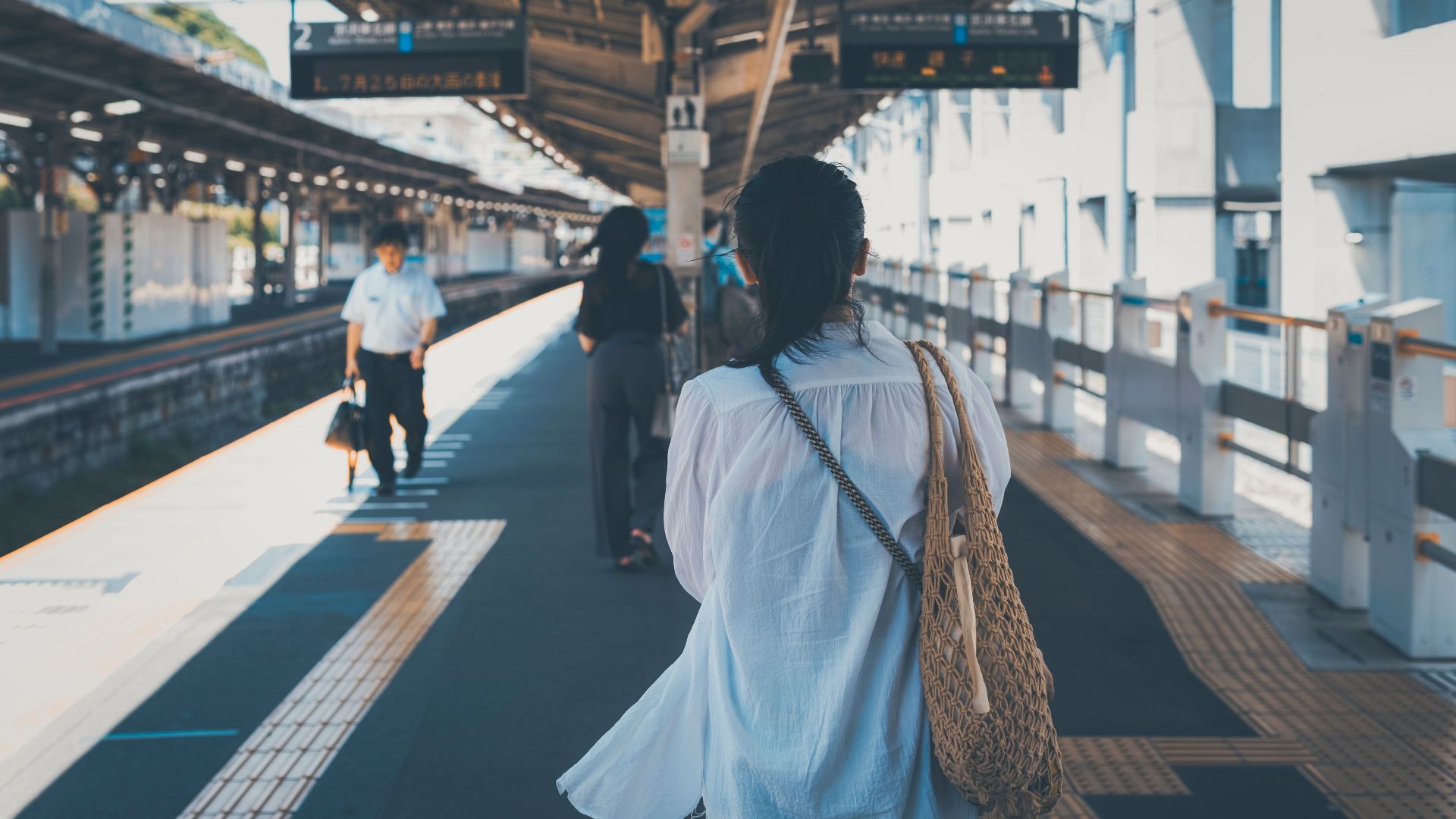 People walking on a platform in a Tokyo train station, capturing daily life.