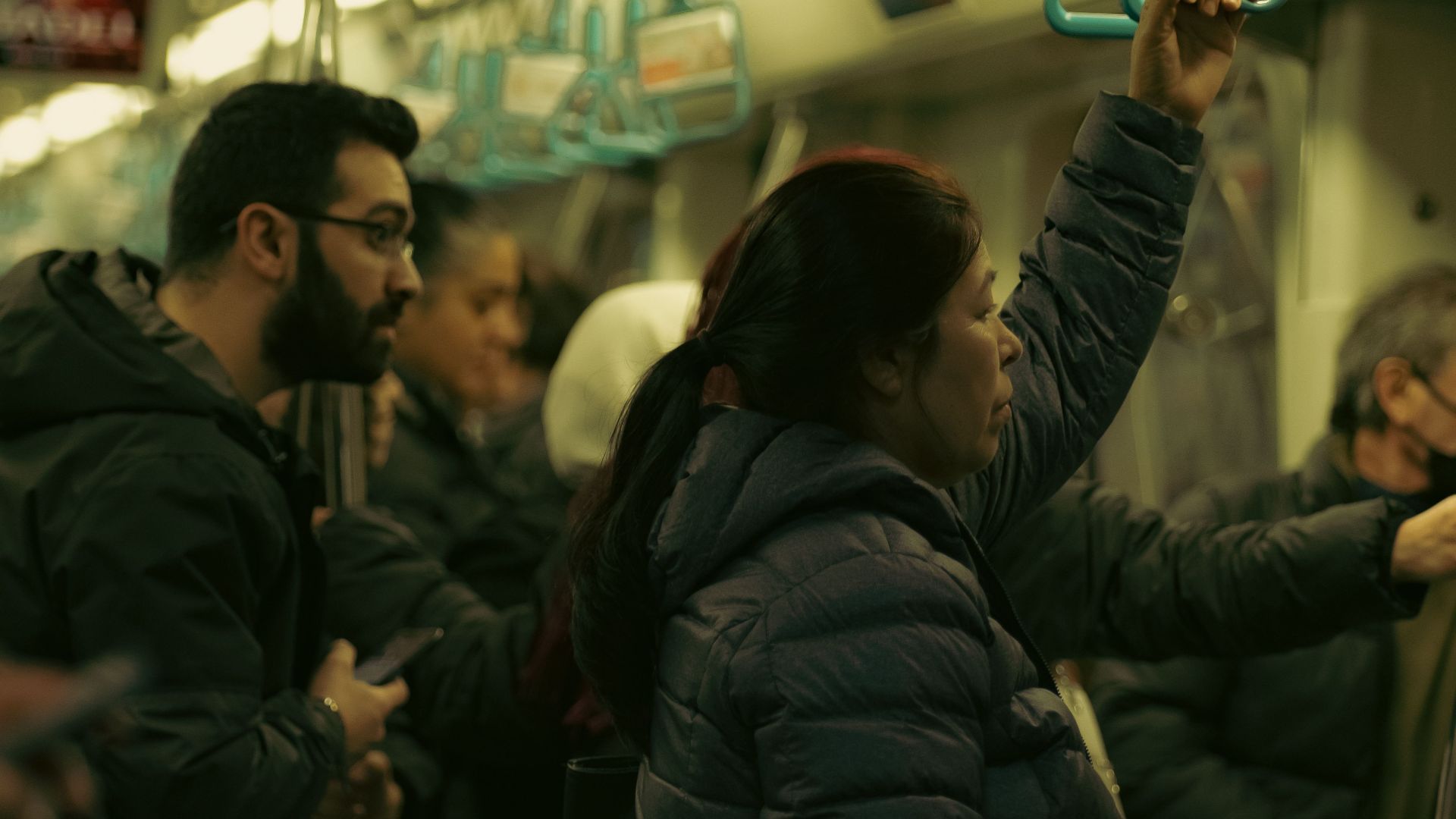 Crowded subway train with commuters standing during an urban travel commute.