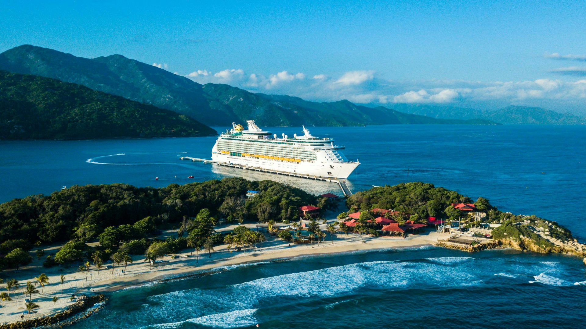 a cruise ship is docked at a small island